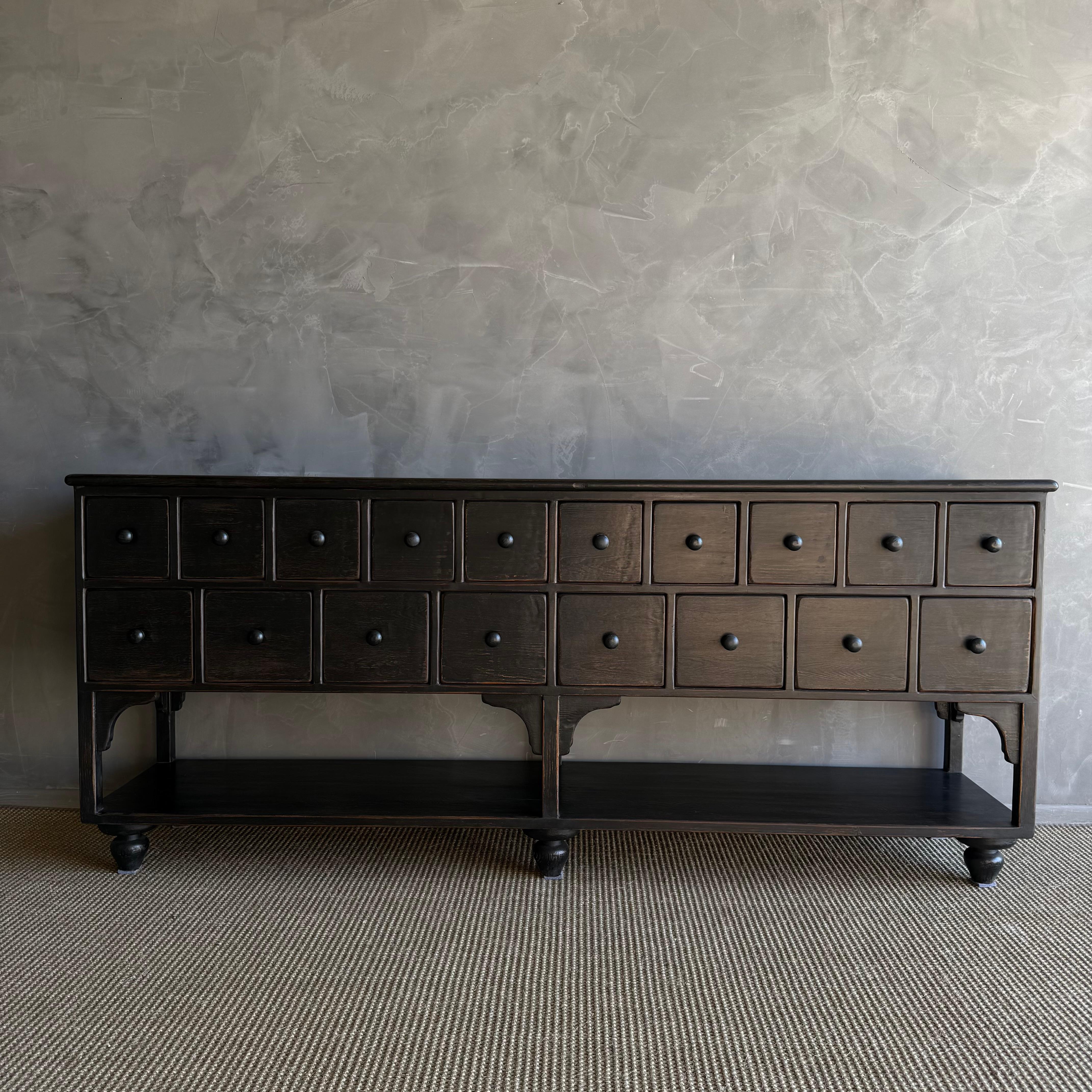 Crafted with reclaimed wood in an ebony painted finish, this console will add a timeless look to any space. With its abundance of drawers, it serves as an excellent entry piece or server, providing storage for all your essentials. All drawers