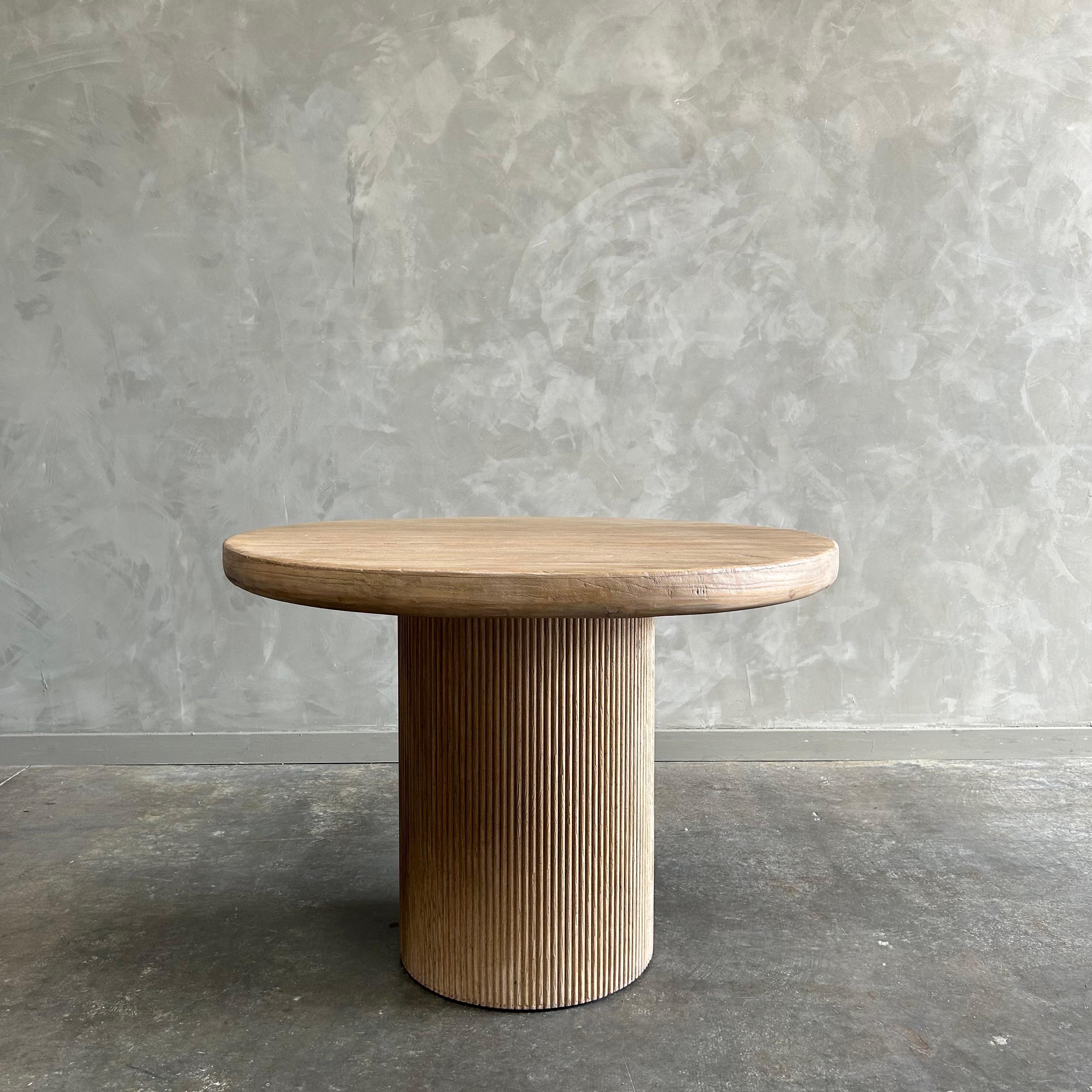 Nori dining table 44” diameter x 30”h
With a fluted column table base, the Nori Dining Table is a modern take on a fluted column base dining table. Made of reclaimed elm, the table’s finish highlights the natural grain and beauty of the wood. The