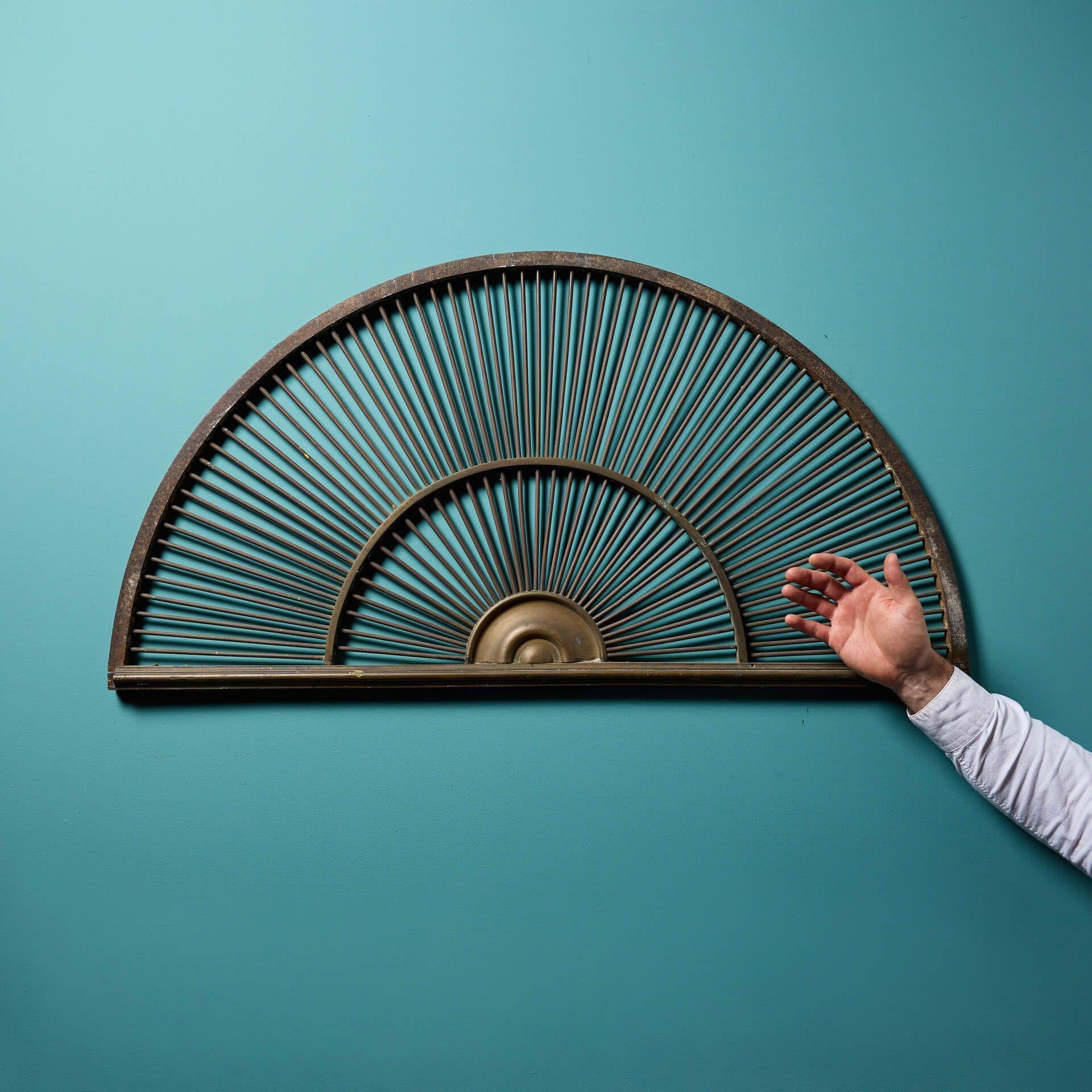 A reclaimed wrought iron fanlight.

This decorative fanlight is perfect for us for over a window or as a piece of art against a wall in a country property or period townhouse.

Its wrought iron body works beautifully with the bronze spokes, creating