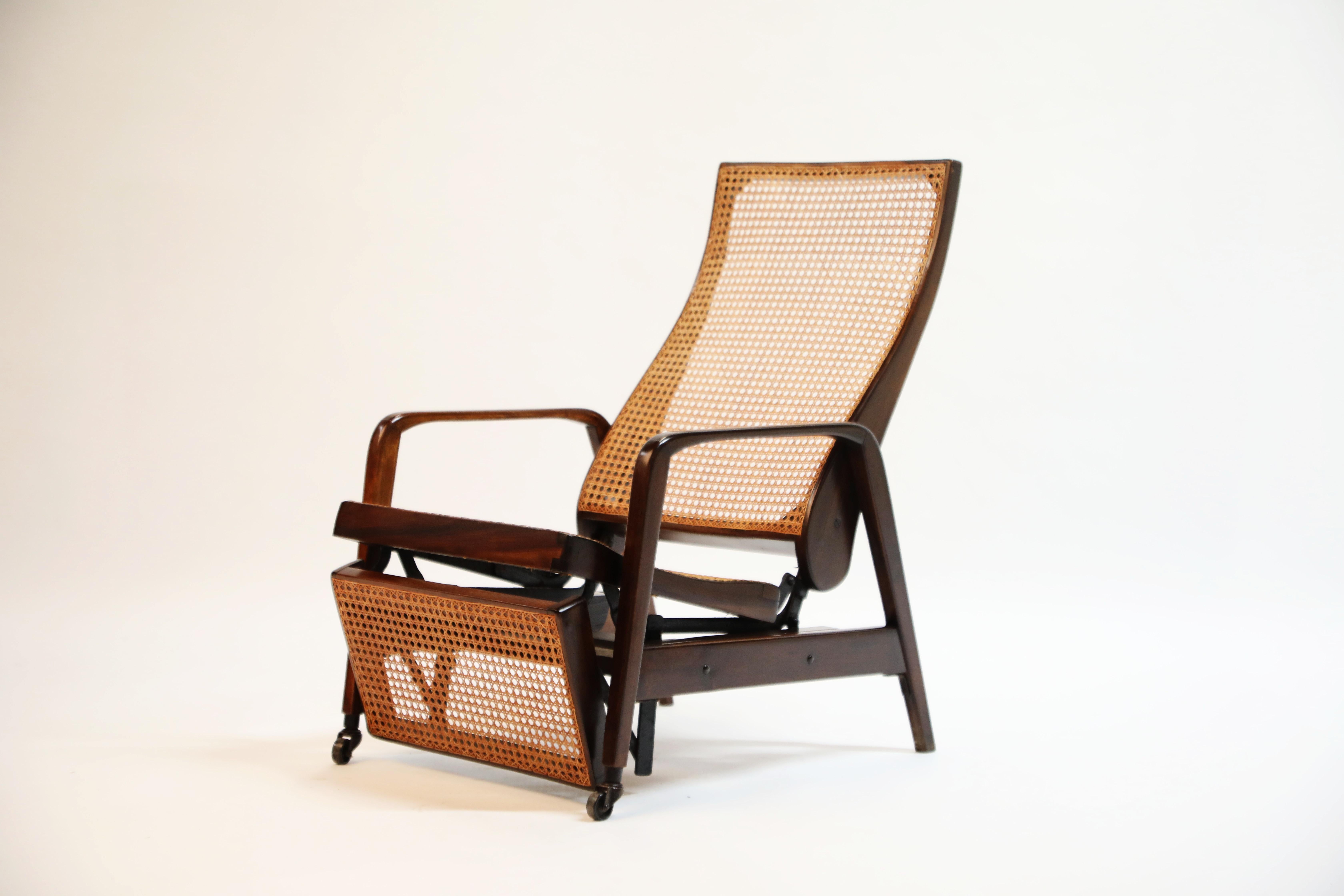 A beautiful caned reclining chair in Brazilian Jacaranda Rosewood made in Brazil circa 1940 with a sweeping curved seat back, sculptural arms and wheeled front legs. We recently imported this piece for Rio de Janeiro where we sourced this along with