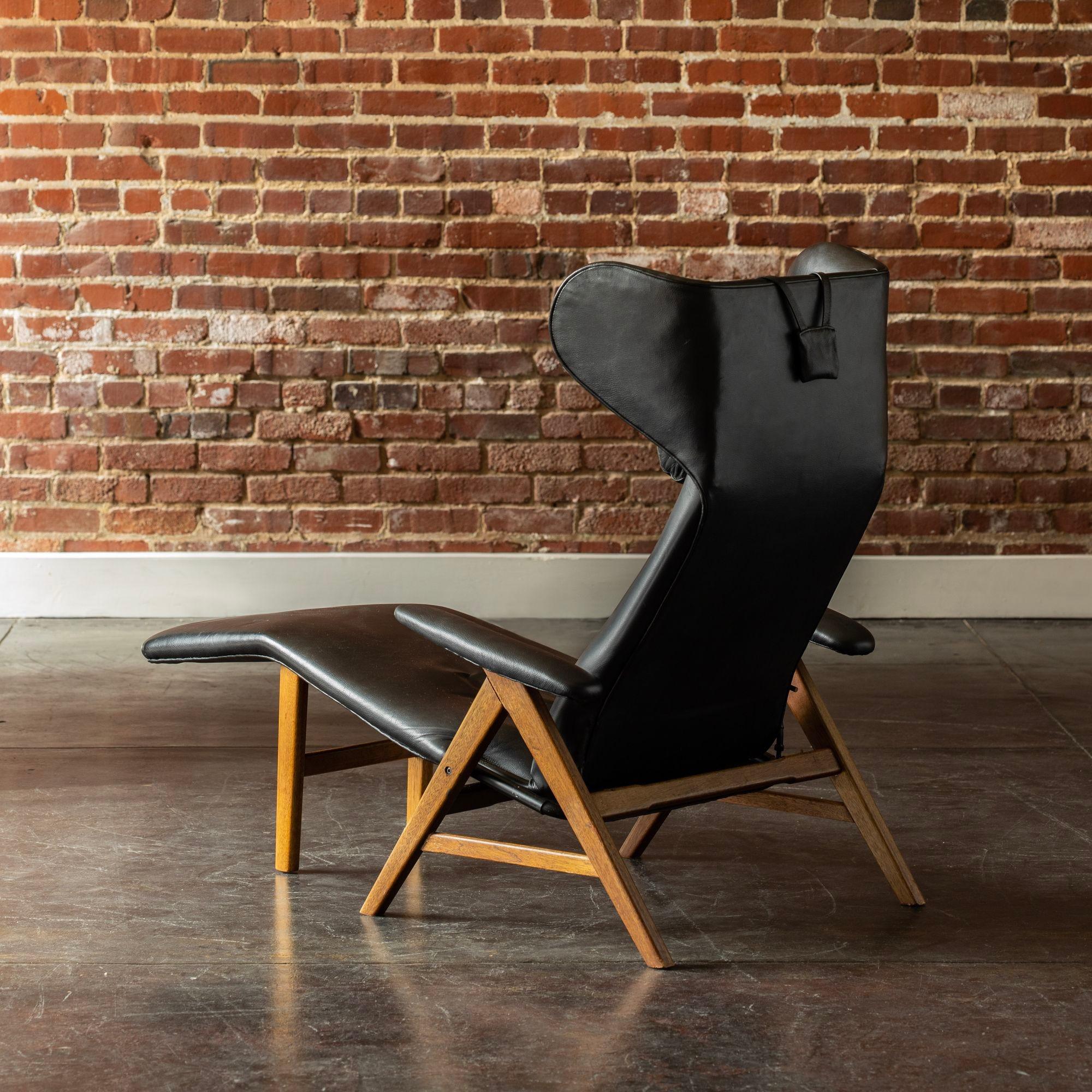 Reclining chair in oak with tilt function designed by Henry W. Klein and manufactured by Bramin Møbler, Denmark, 1960s. In original black leather.
H 39 in x W 30 in x D 55.5 in
H 99.06 cm x W 76.2 cm x D 140.97 cm
Seat Height: 13.5 in 34.29 cm.