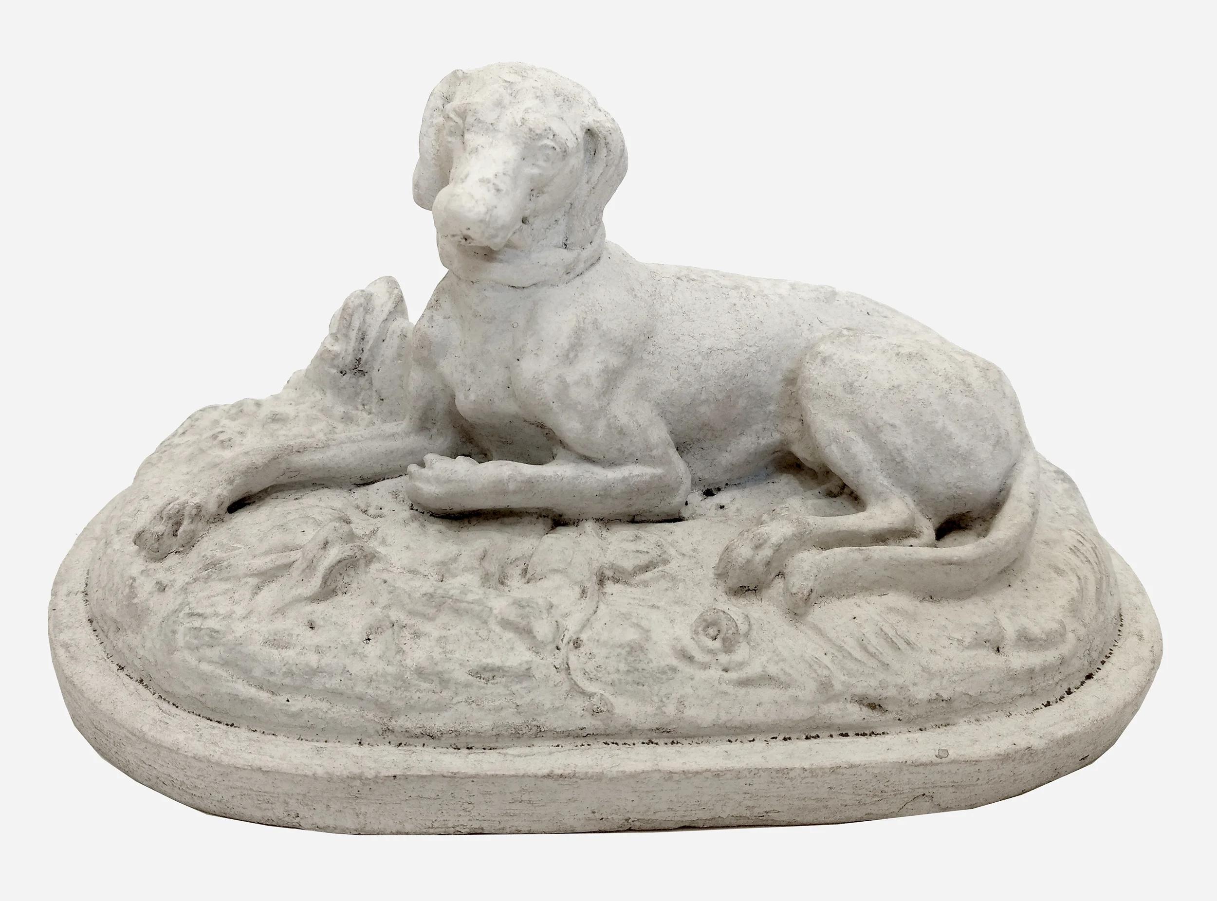 Plaster statuette representing a lying dog.
France, circa 1880.