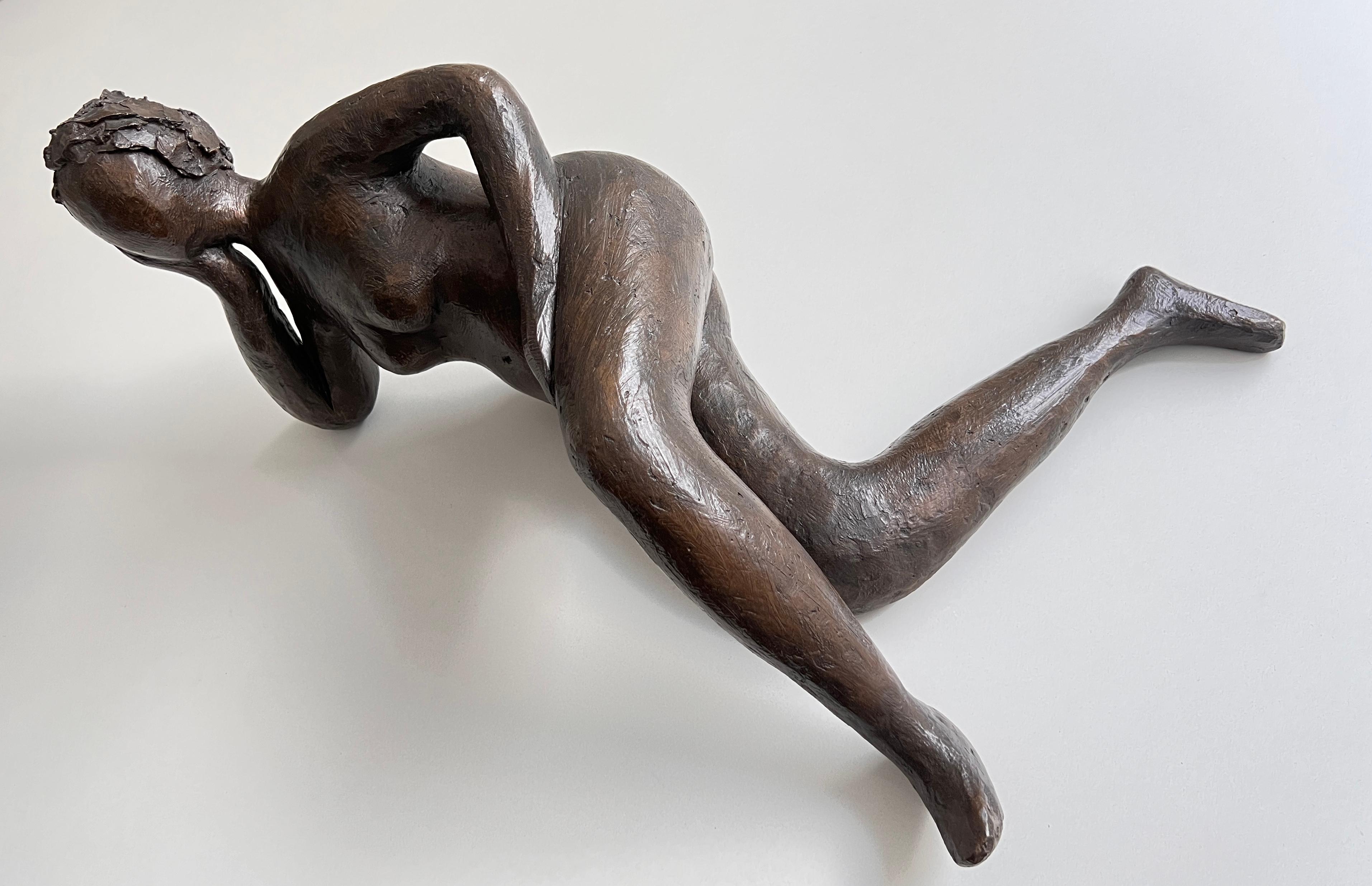 A beautiful  sculpture of a reclining figure of an abstract female nude. The substantial piece is 70cm long,  hand crafted, molded and cast in a mix of resin and bronze powder, which gives it a striking finish. The sculpture's dark bronze patina