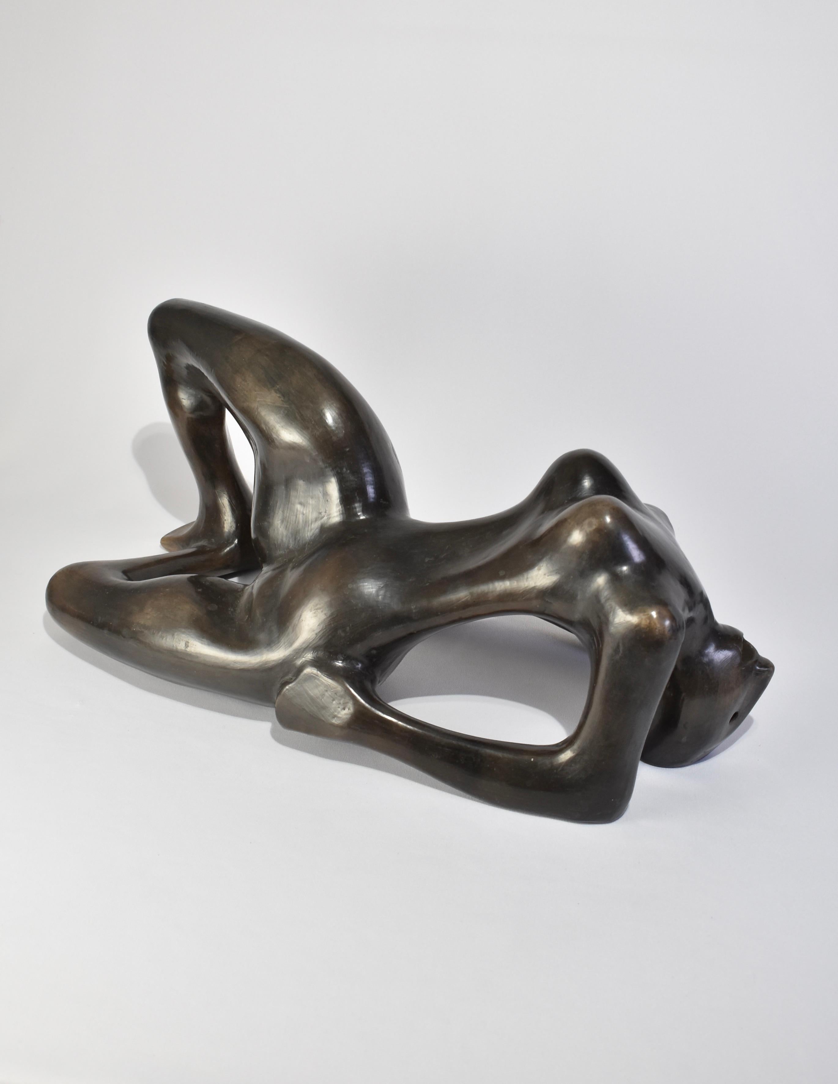 Stunning, black molded ceramic reclining figure sculpture in the style of Henry Moore, ca. 1960s. Illegibly signed on one foot.