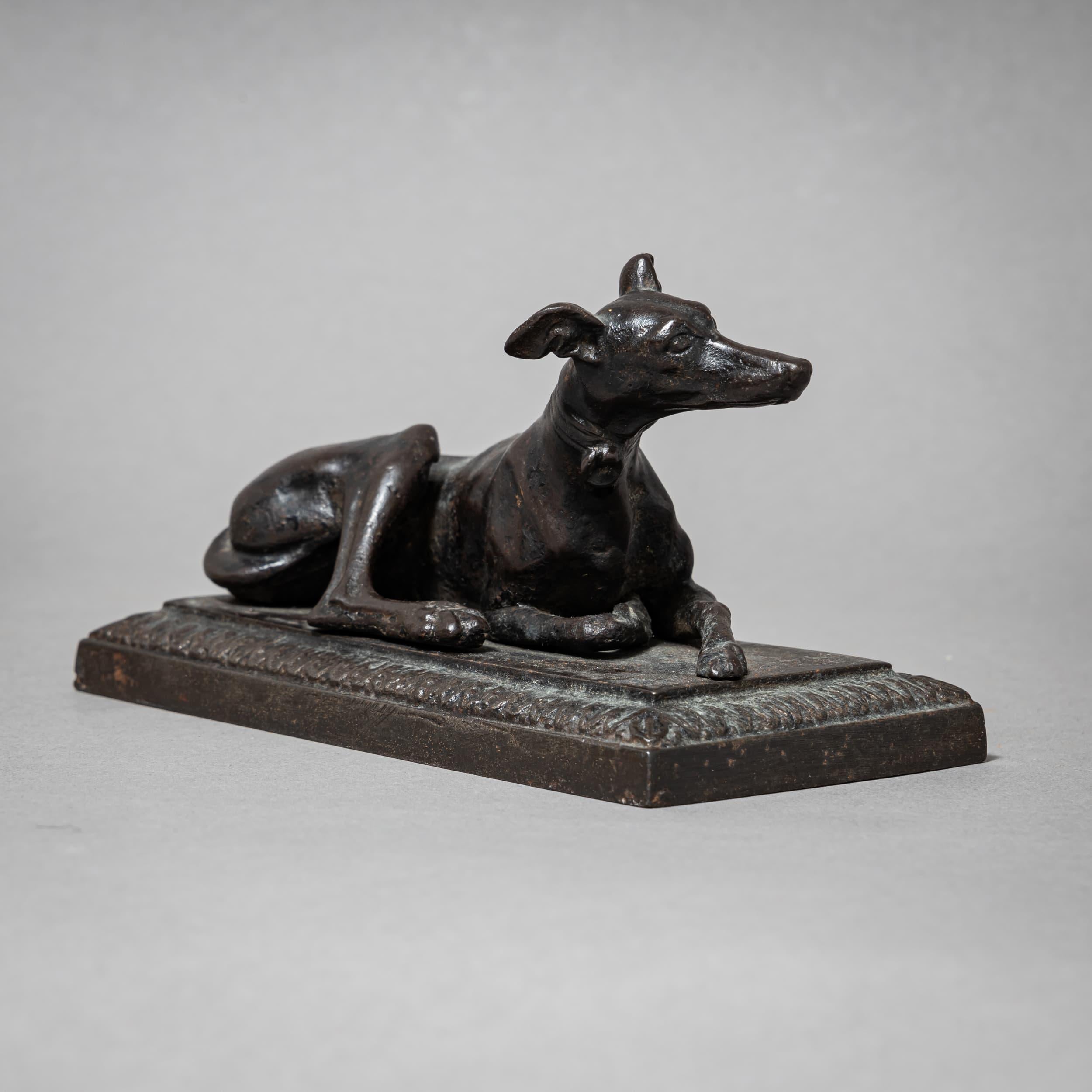 Figure of a reclining greyhound in Berlin iron, with raised head and pointed ears. The finely modeled sculpture rests on a rectangular base adorned with a continuous cyma molding frieze. A characteristic example of Berlin’s delicate iron castings