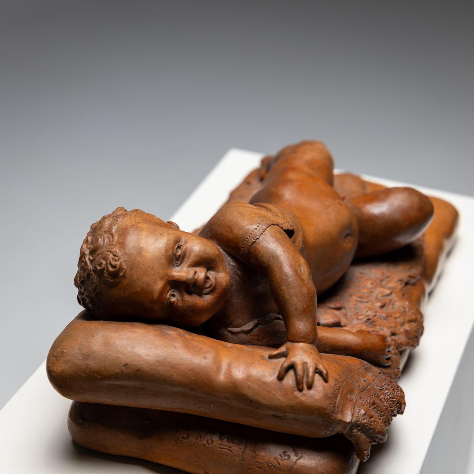 19th Century Reclining infant in terracotta, sign. F. Sans, probably Spain, Late 19th century For Sale