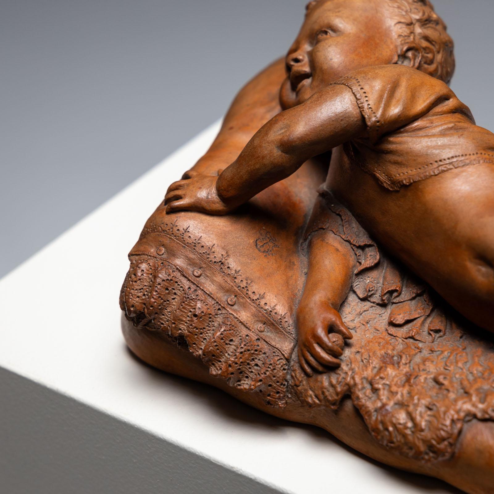 Terracotta Reclining infant in terracotta, sign. F. Sans, probably Spain, Late 19th century For Sale