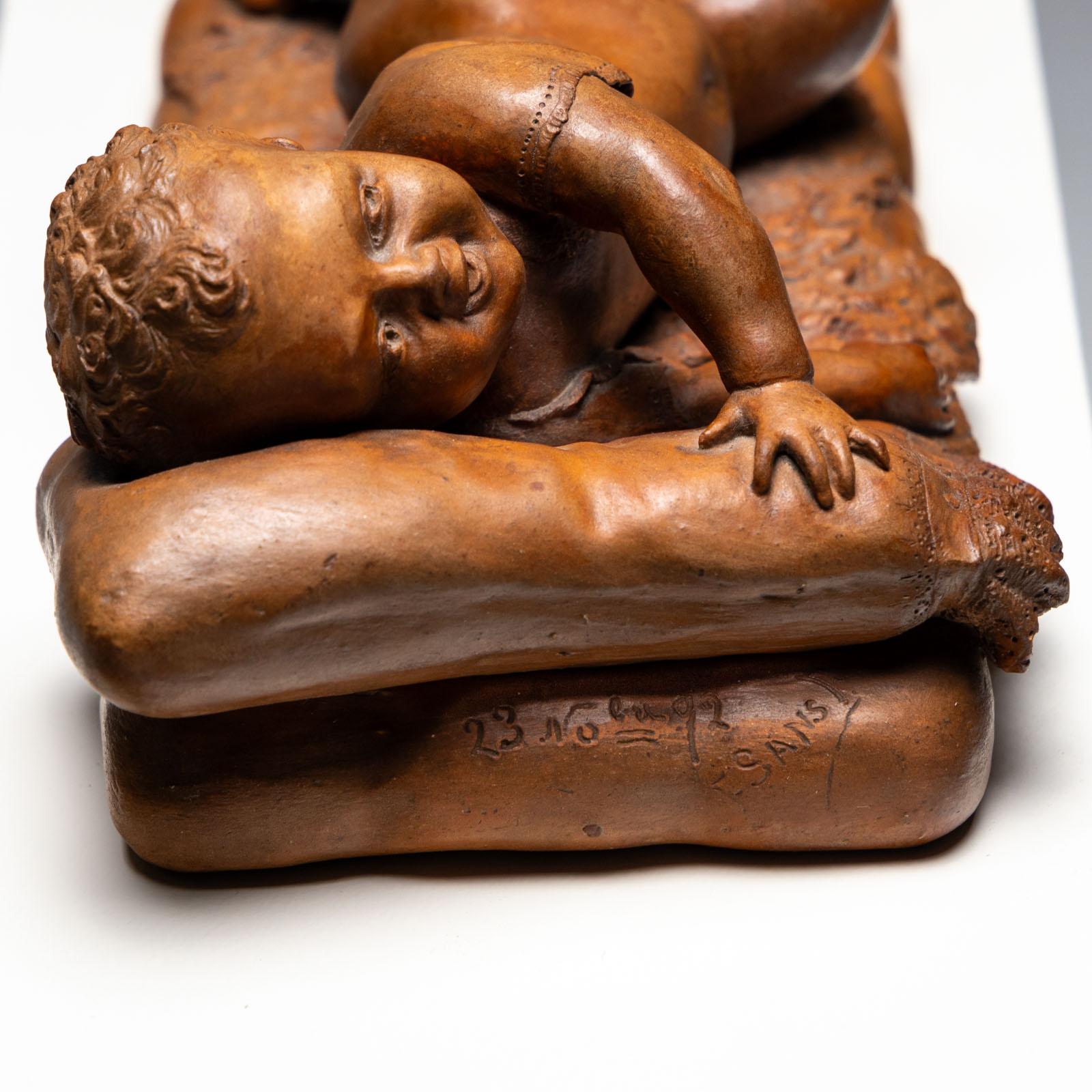 Reclining infant in terracotta, sign. F. Sans, probably Spain, Late 19th century For Sale 1