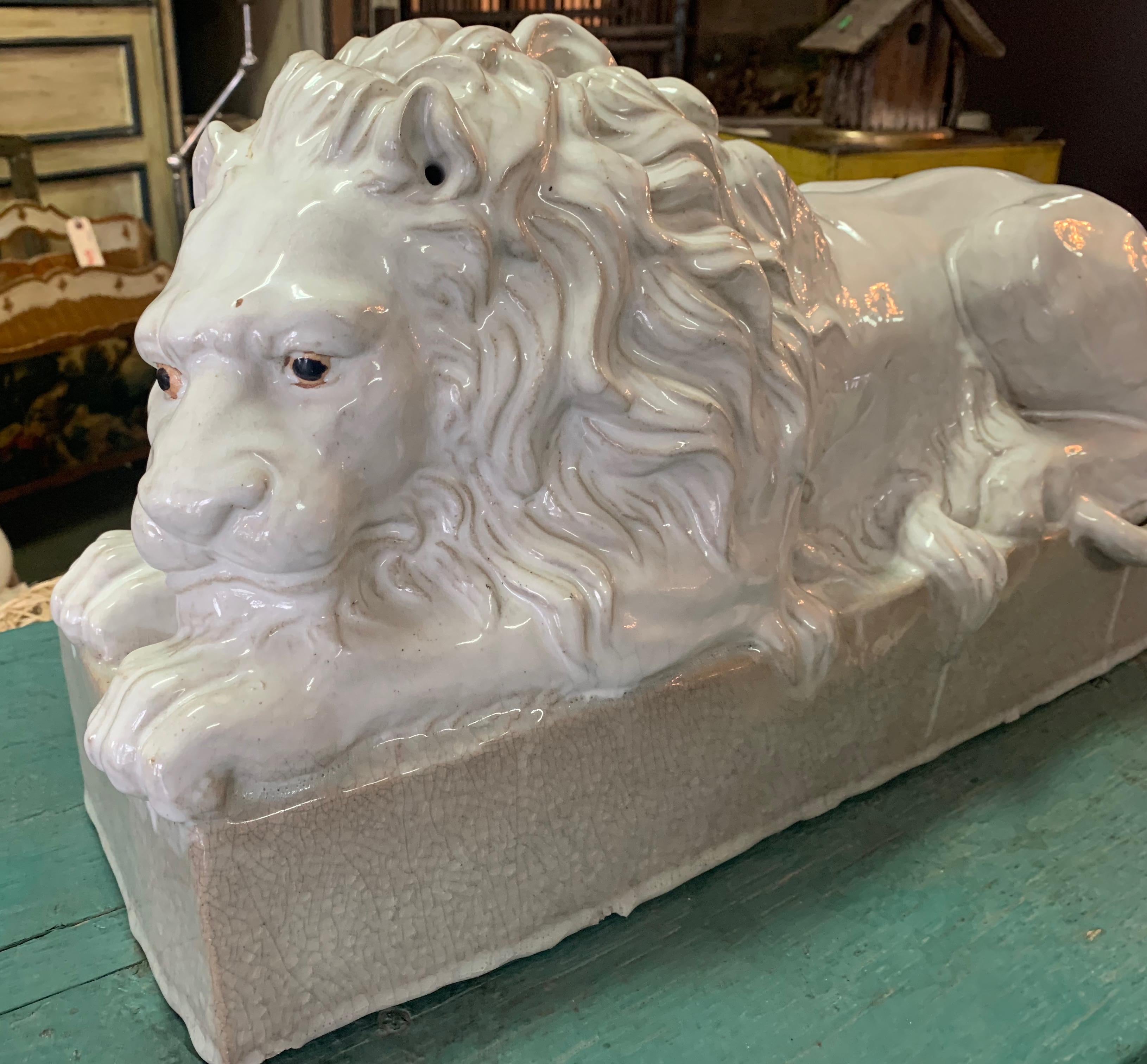 Handsome Italian reclining terracotta lion - A wonderful addition to many settings, shelves, center pieces or decorative piece. Large and substantial with wonderful terra cotta character.