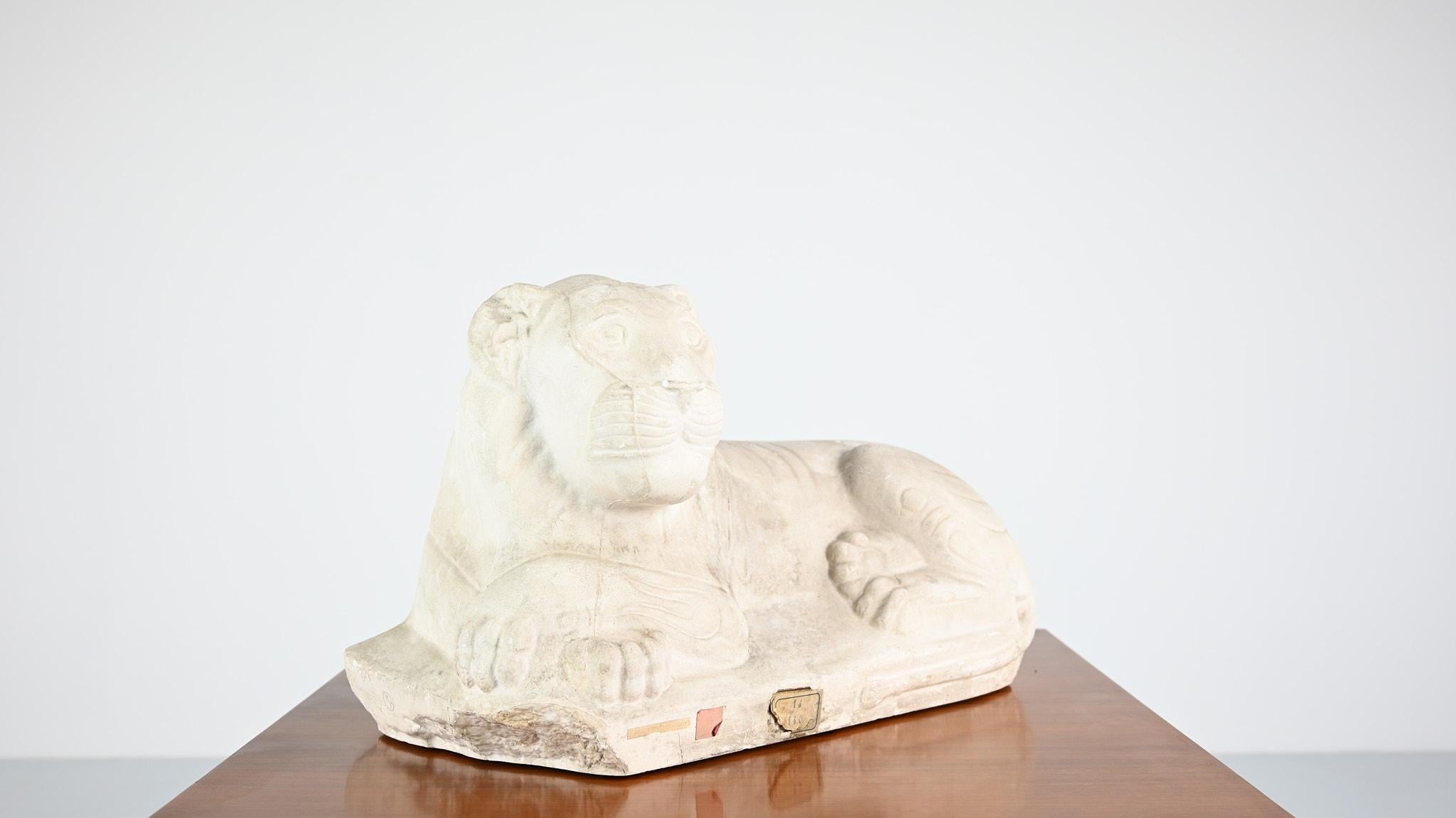 Archaistic Reclining lion, vintage reproduction in plaster. France, C.1970