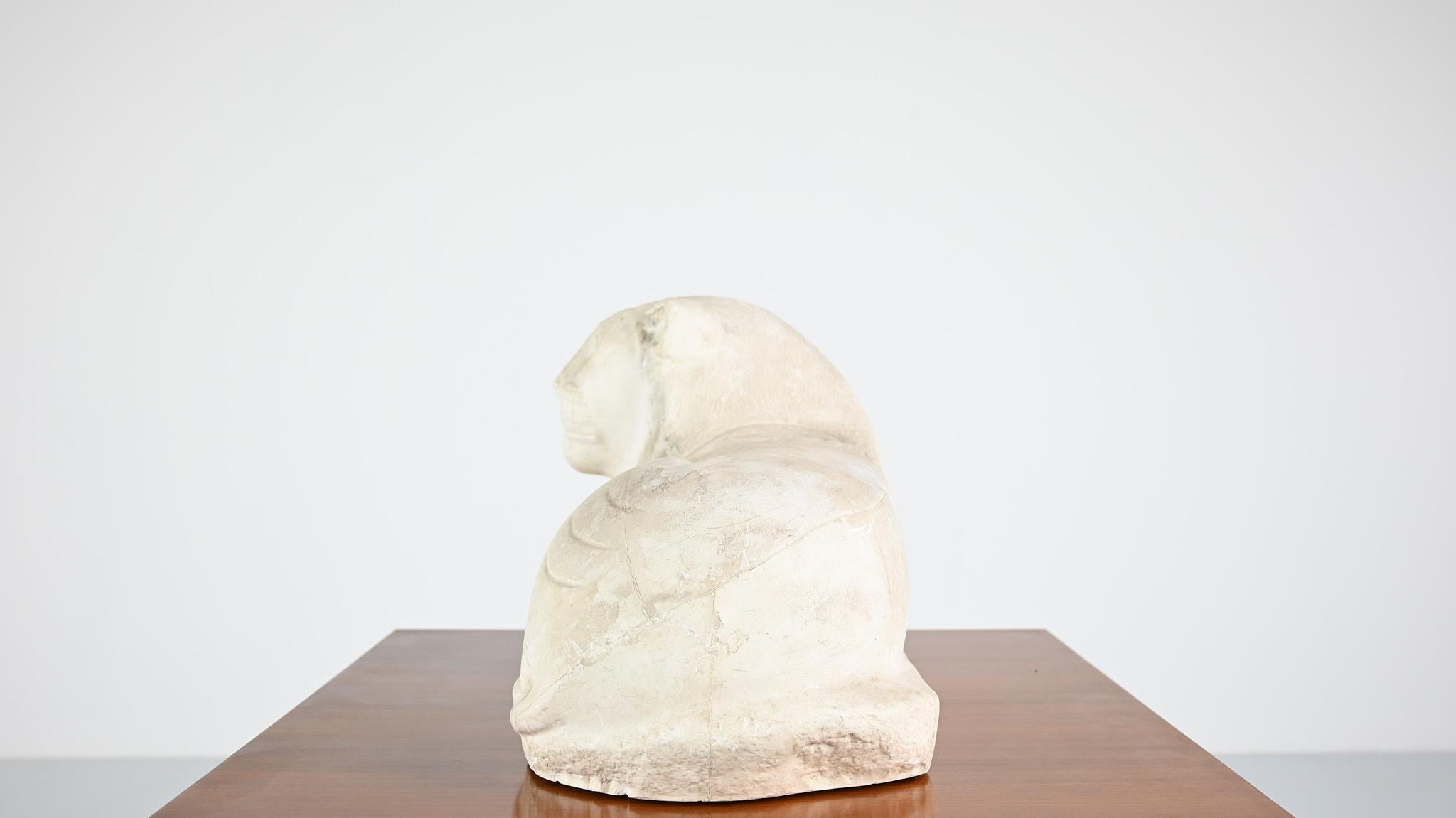 Plaster Reclining lion, vintage reproduction in plaster. France, C.1970