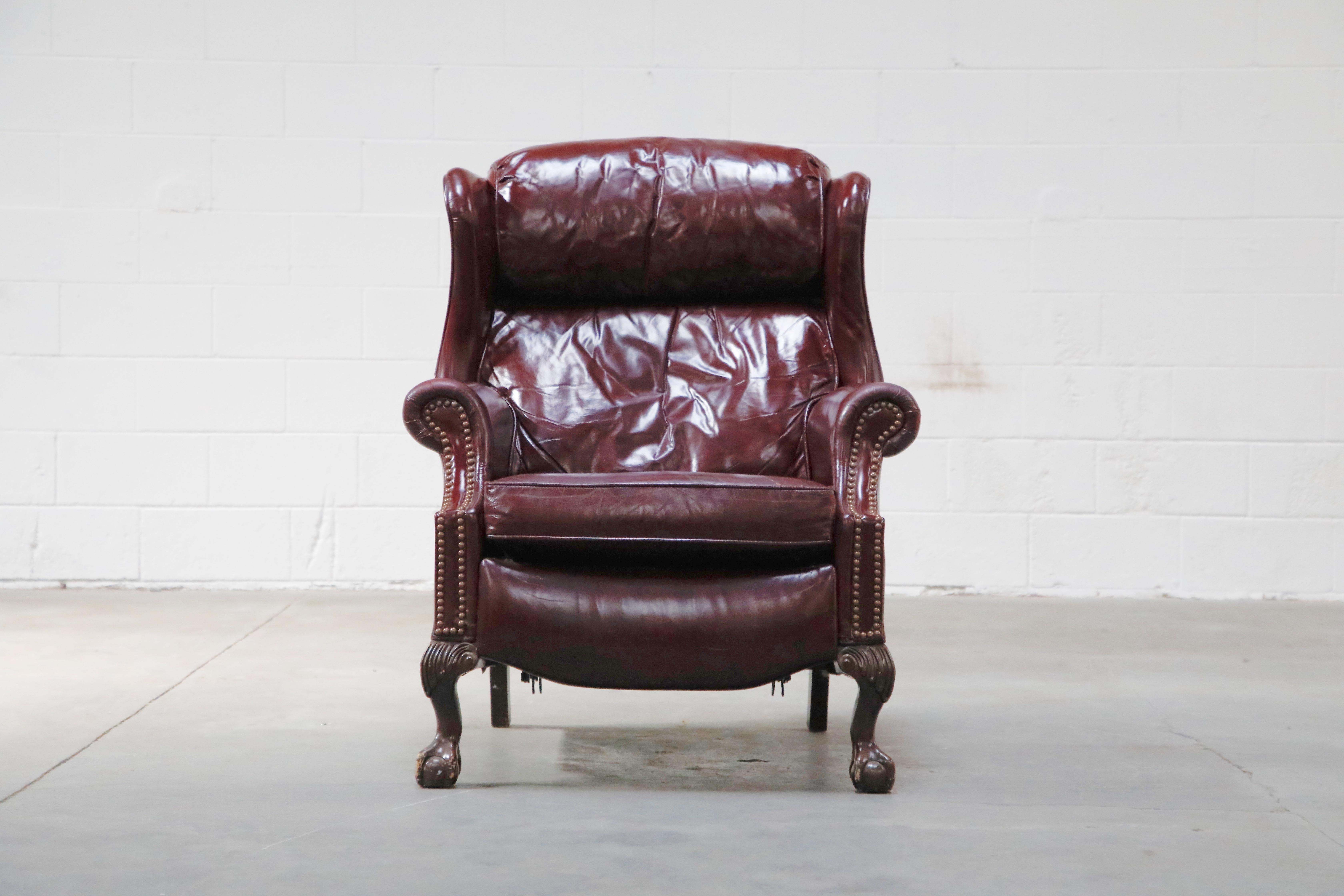 Add a touch of nobility to your space with this reclining Napoleon III style leather wingback fireplace armchair by Bradington Young, a quality manufacturer in North Carolina for over 30 years. This handsome reclining lounge chair is upholstered in