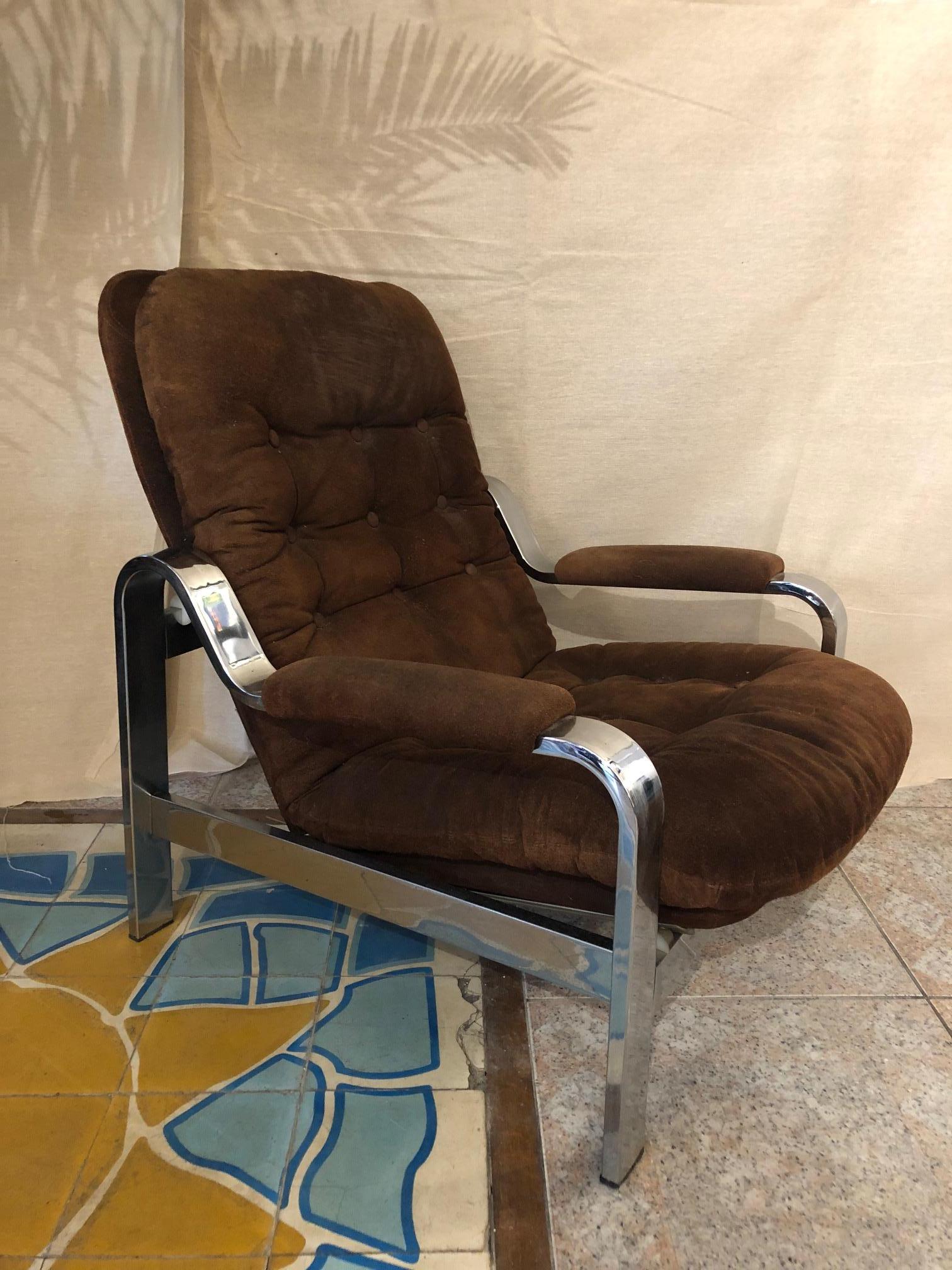 Comfortable armchair with chrome structure and suede upholstery from the 1970s
matching ottoman.