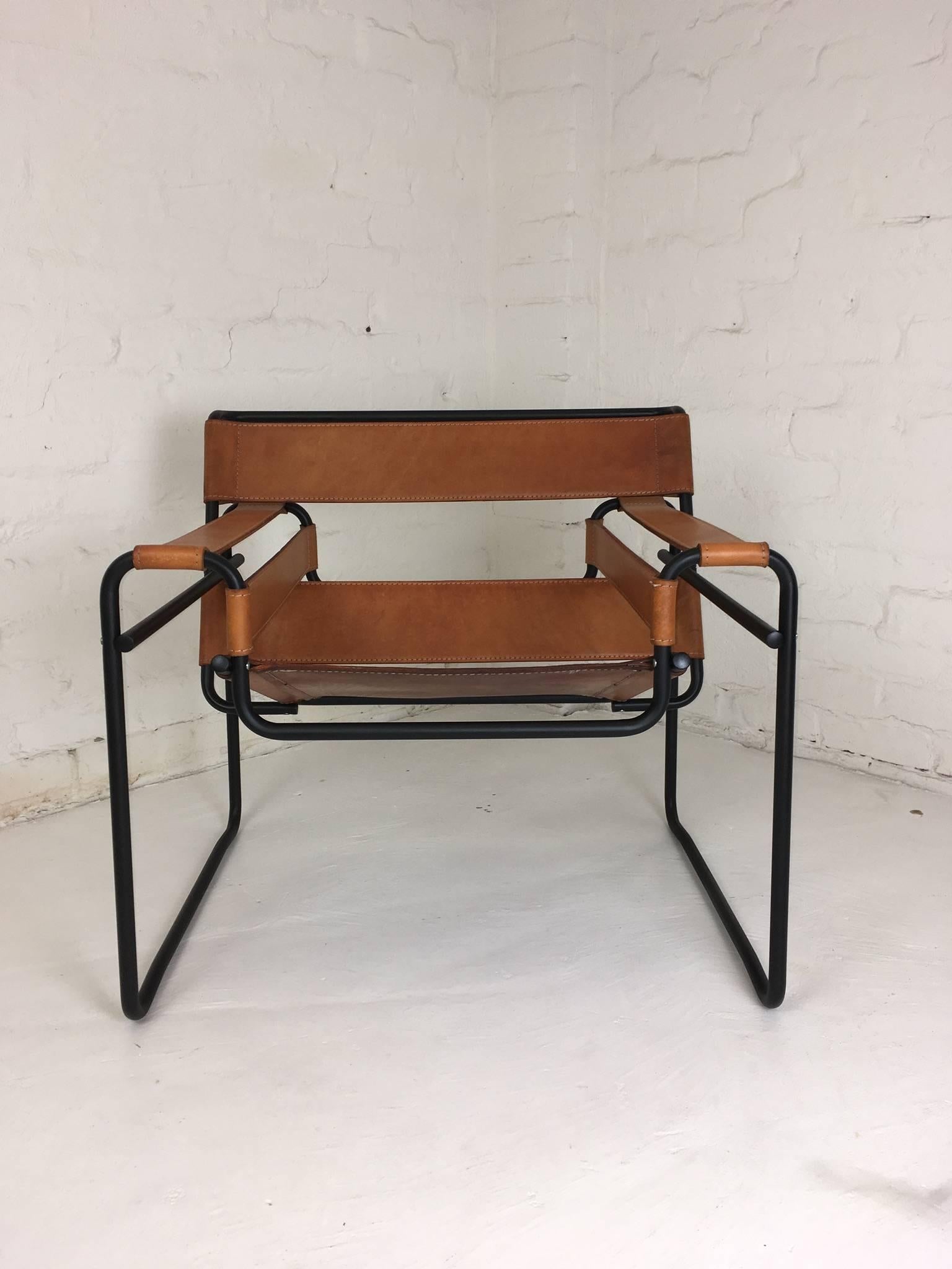 This is a restoration of a 1990s reproduction of Marcel Breuer's Sassily chair. We've taken a panel of saddle leather from this chair's damaged pair and used it to reinforce the seat, making a very strong double layer of saddle leather,