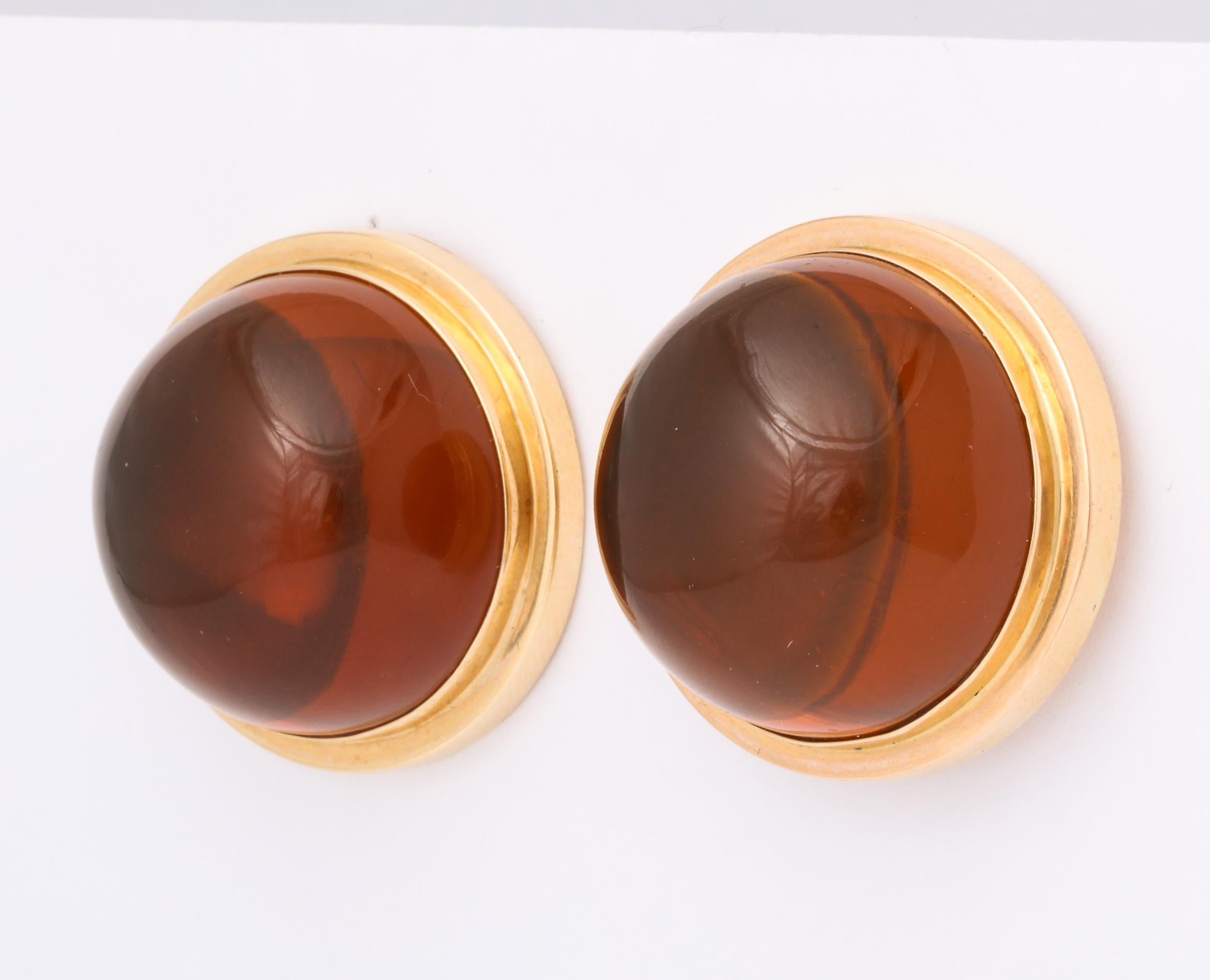  Reconstituted and polished Amber Beads set in double stepped   18kt Yellow Gold bezel mounting.  Clip on with Omega Backs. Marked 18kt.  Large scale -  Beads measure 26mm. Bold look and very rich.  Can be converted to pierced.  They are a match to