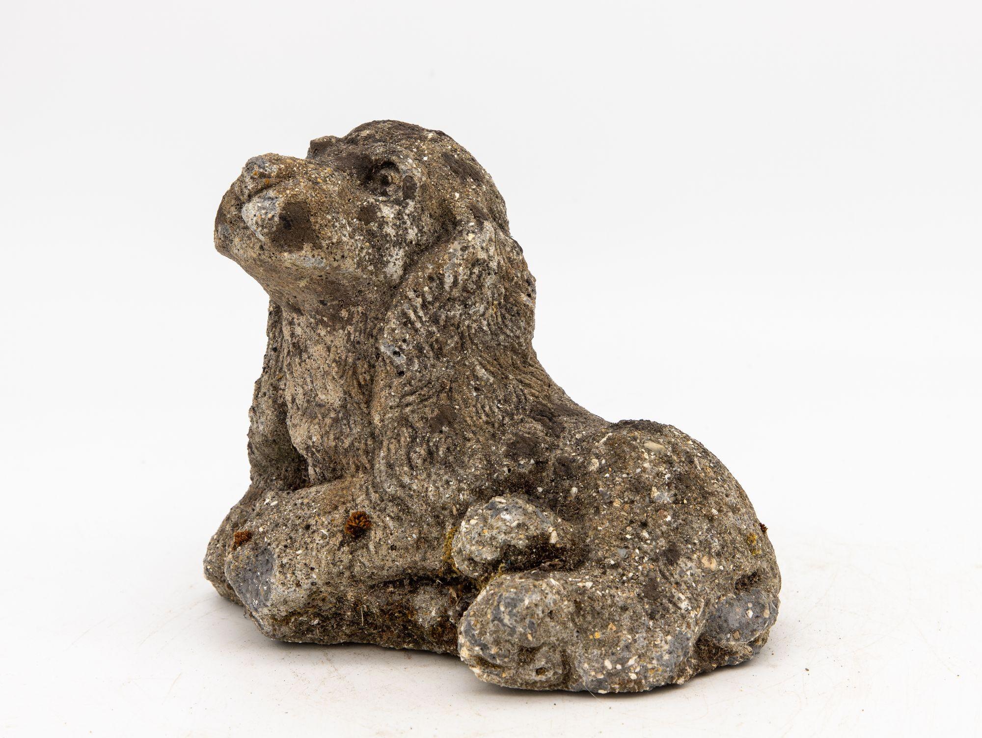 This heartwarming Mid-20th Century concrete dog spaniel garden ornament exudes an authentic vintage charm that adds a touch of personality to any outdoor space. This delightful figurine, skillfully crafted from resilient concrete, captures the