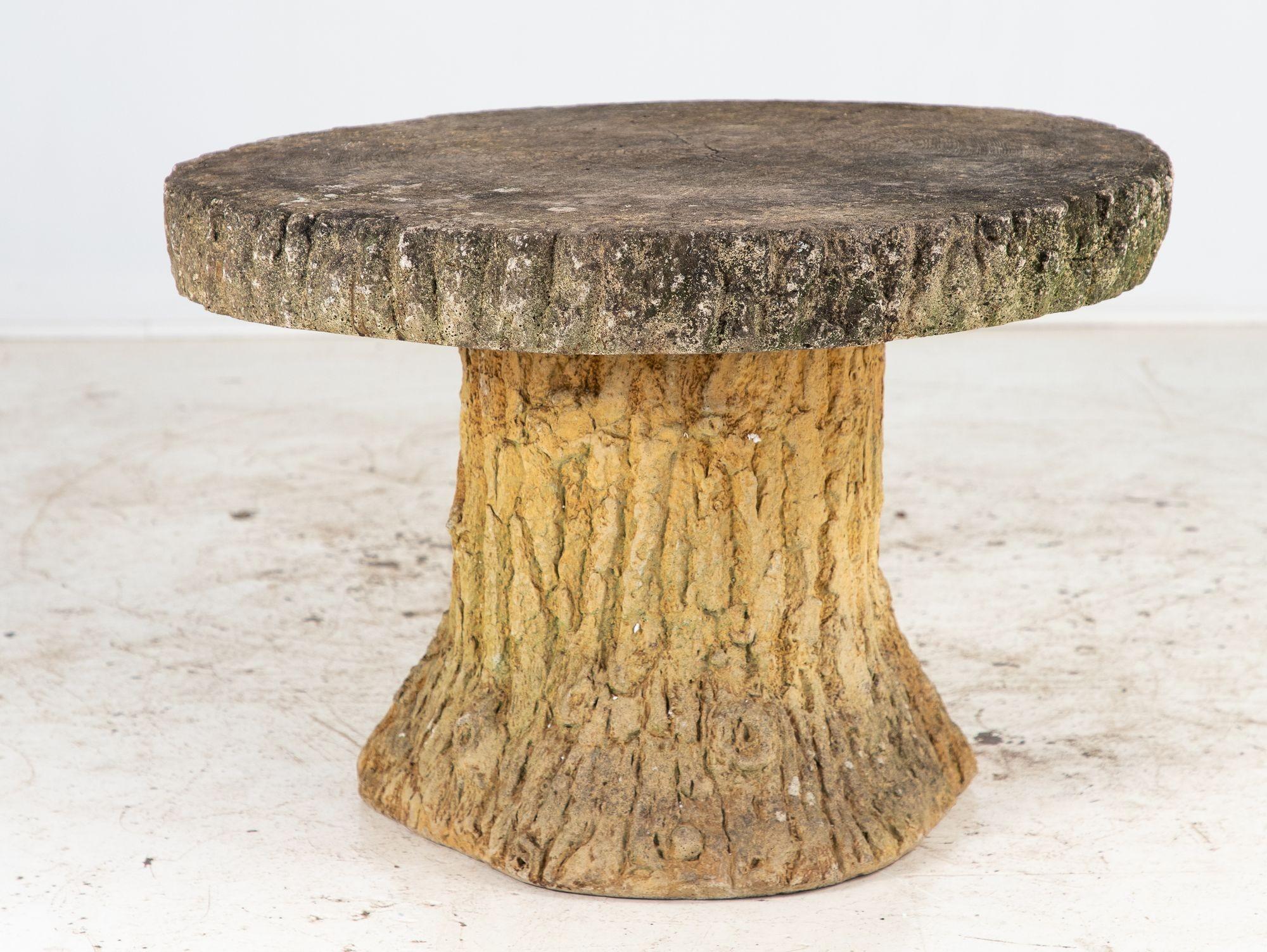 Whimsical reconstituted stone round outdoor patio table with a stylized faux bois base, top, and stools, made in France, Mid-20th century. Round slab tabletop is supported by a sturdy base in the shape of a tree stump. The base, edge of table, and