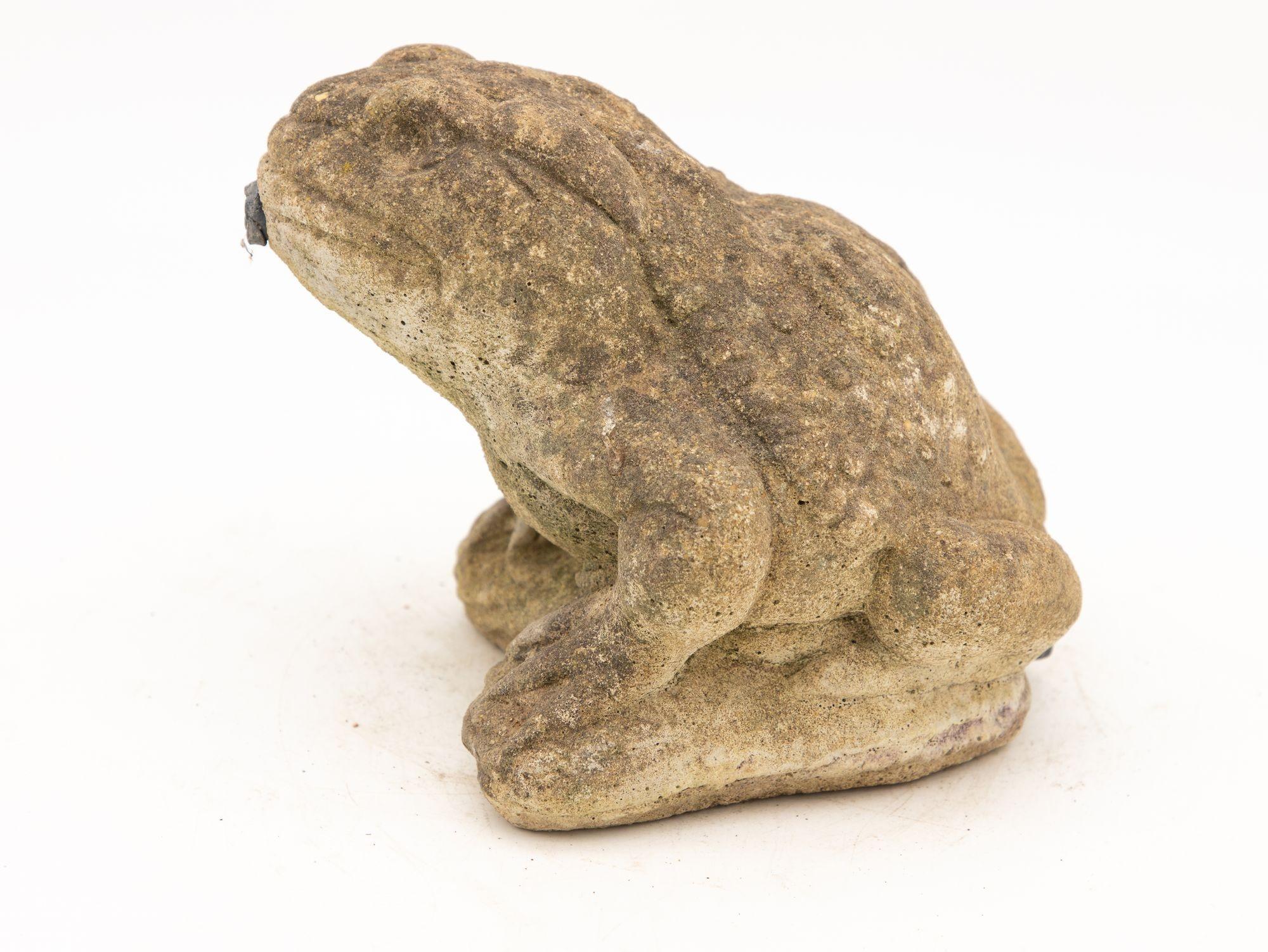 The small concrete frog fountain is a delightful addition to any outdoor space, exuding whimsy and tranquility. With its charming design, it features a playful frog perched atop a pond rock. This small fountain showcases lifelike details to add a
