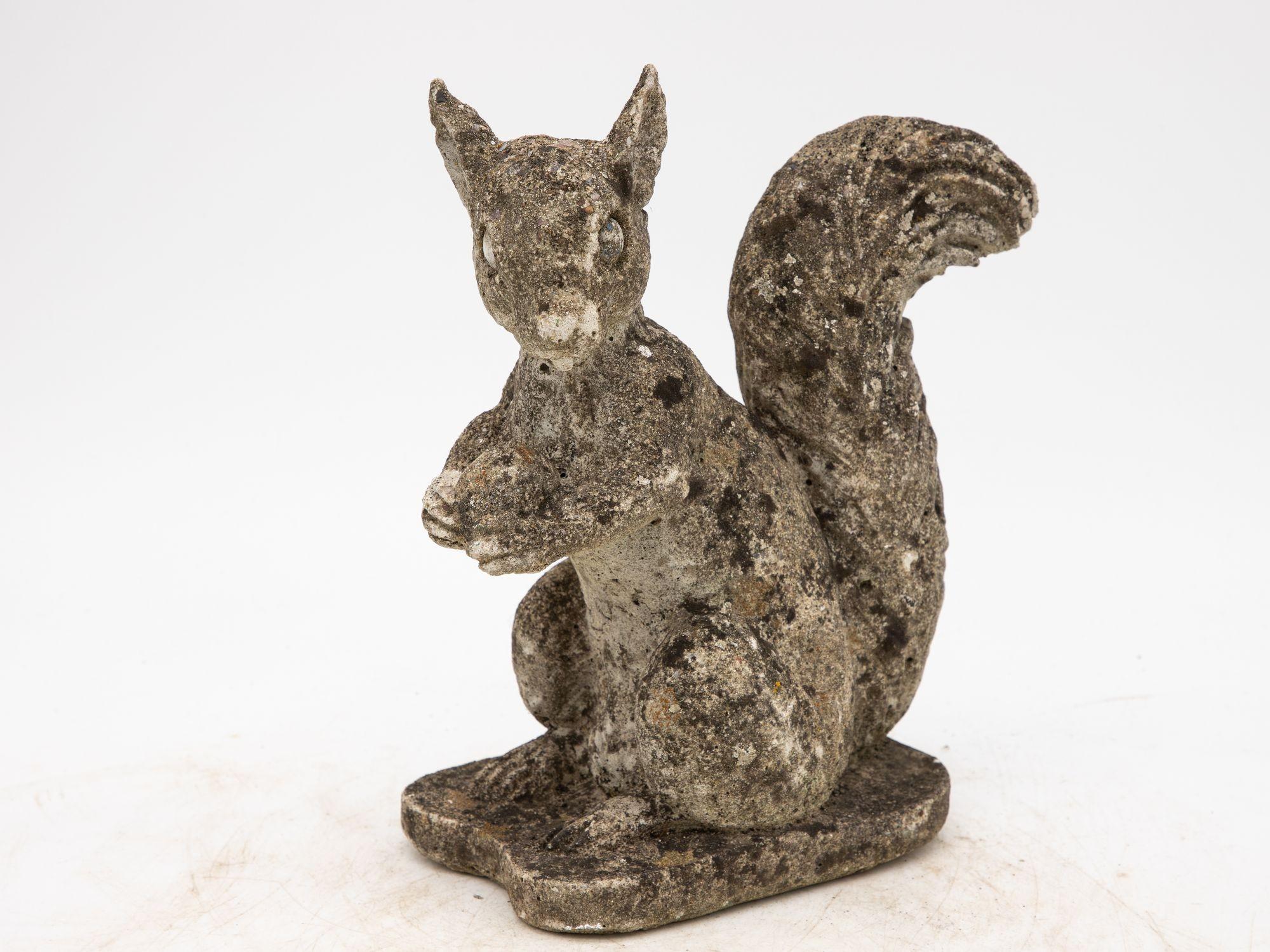 This delightful mod 20th Century concrete squirrel garden ornament is the epitome of outdoor charm. This enchanting piece, meticulously crafted from sturdy concrete, captures the essence of a playful squirrel in lifelike detail. From its curious