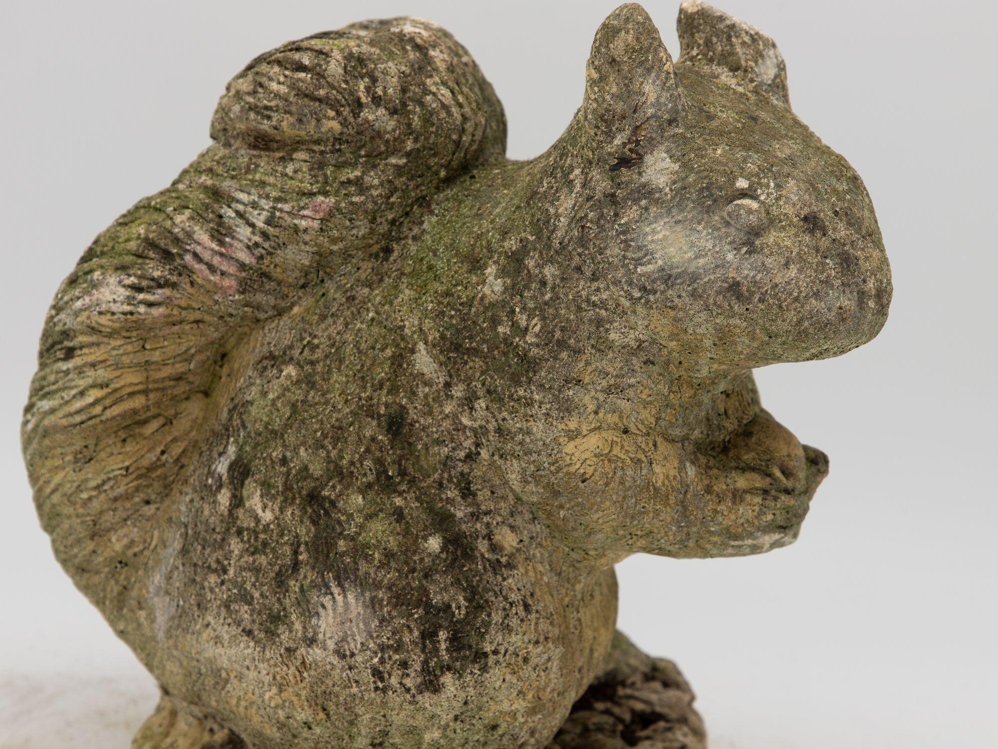 This delightful mid 20th Century concrete squirrel garden ornament is the epitome of outdoor charm. This enchanting piece, meticulously crafted from sturdy concrete, captures the essence of a playful squirrel in lifelike detail. From its curious