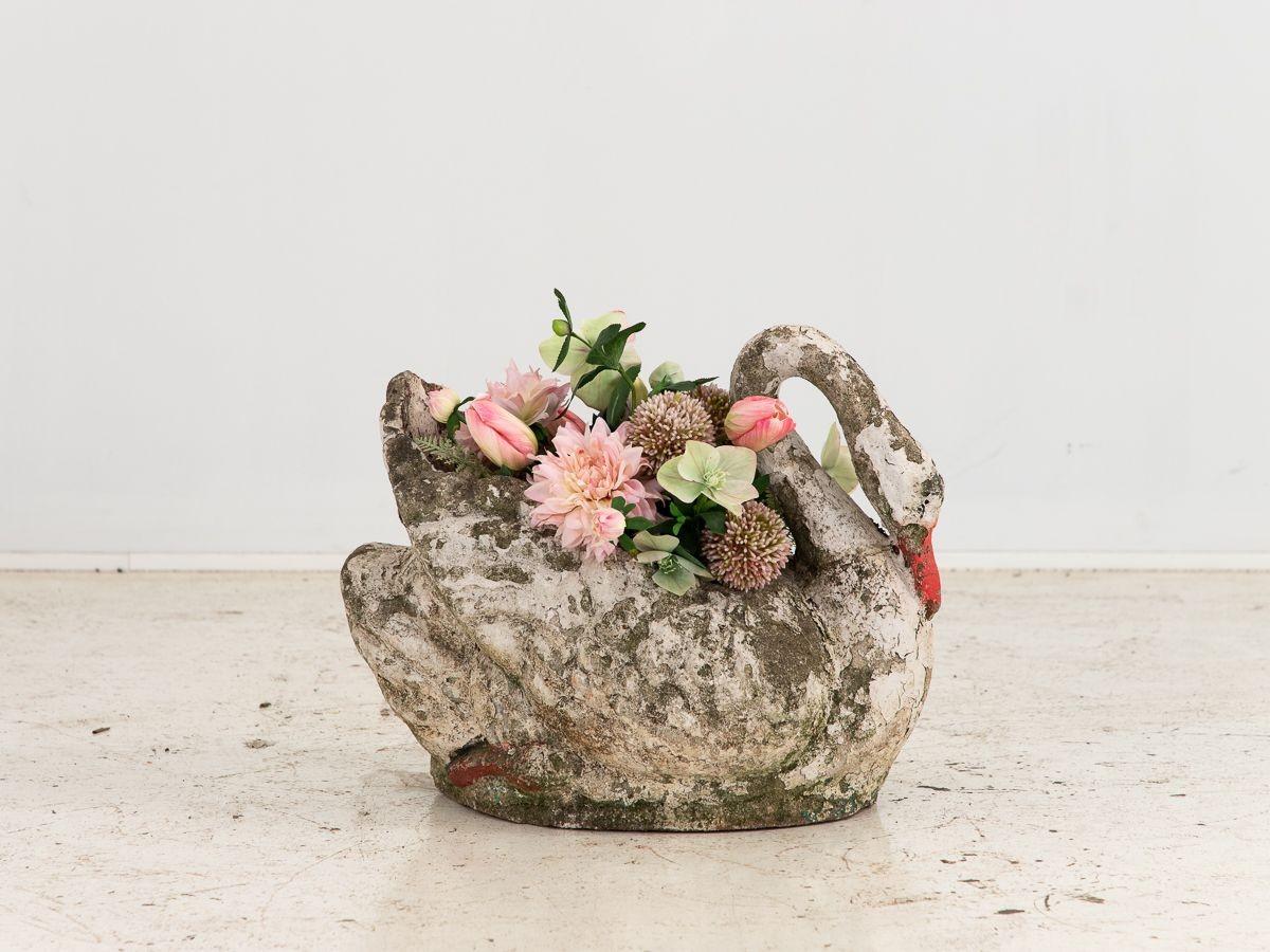 This exceptional concrete swan planter embodies both beauty and functionality in a single piece. With its graceful curved neck and elegant form, it effortlessly captures attention and adds a touch of sophistication to any outdoor or indoor space.