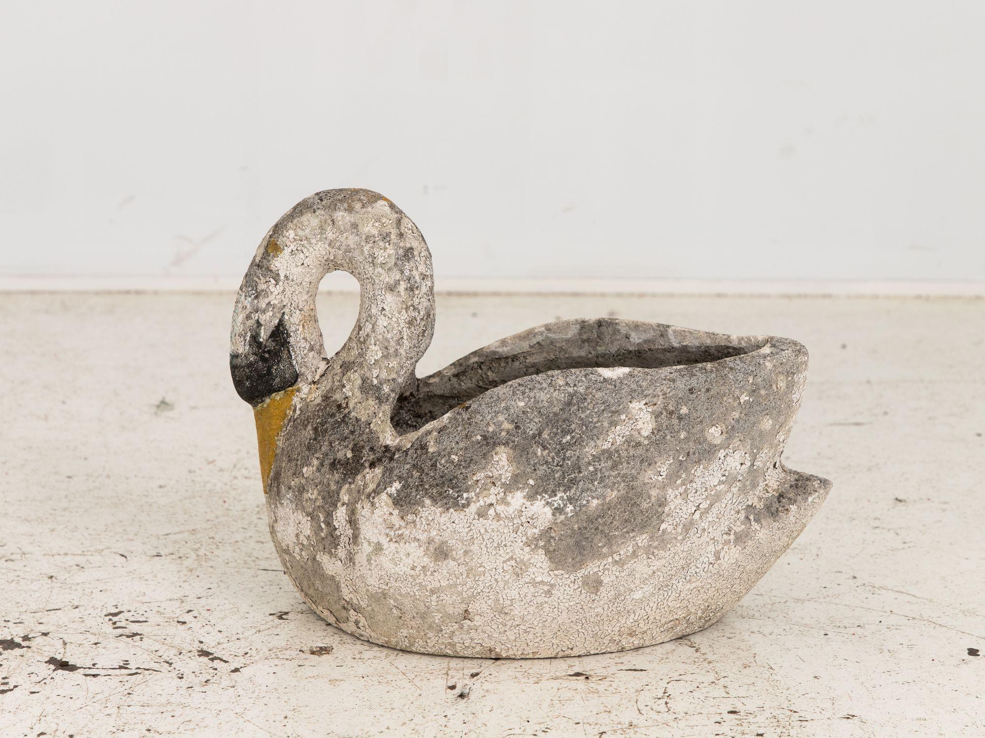 This concrete swan planter embodies both beauty and functionality in a single piece. With its graceful curved neck and elegant form, it effortlessly captures attention and adds a touch of sophistication to any outdoor or indoor space. This lovely
