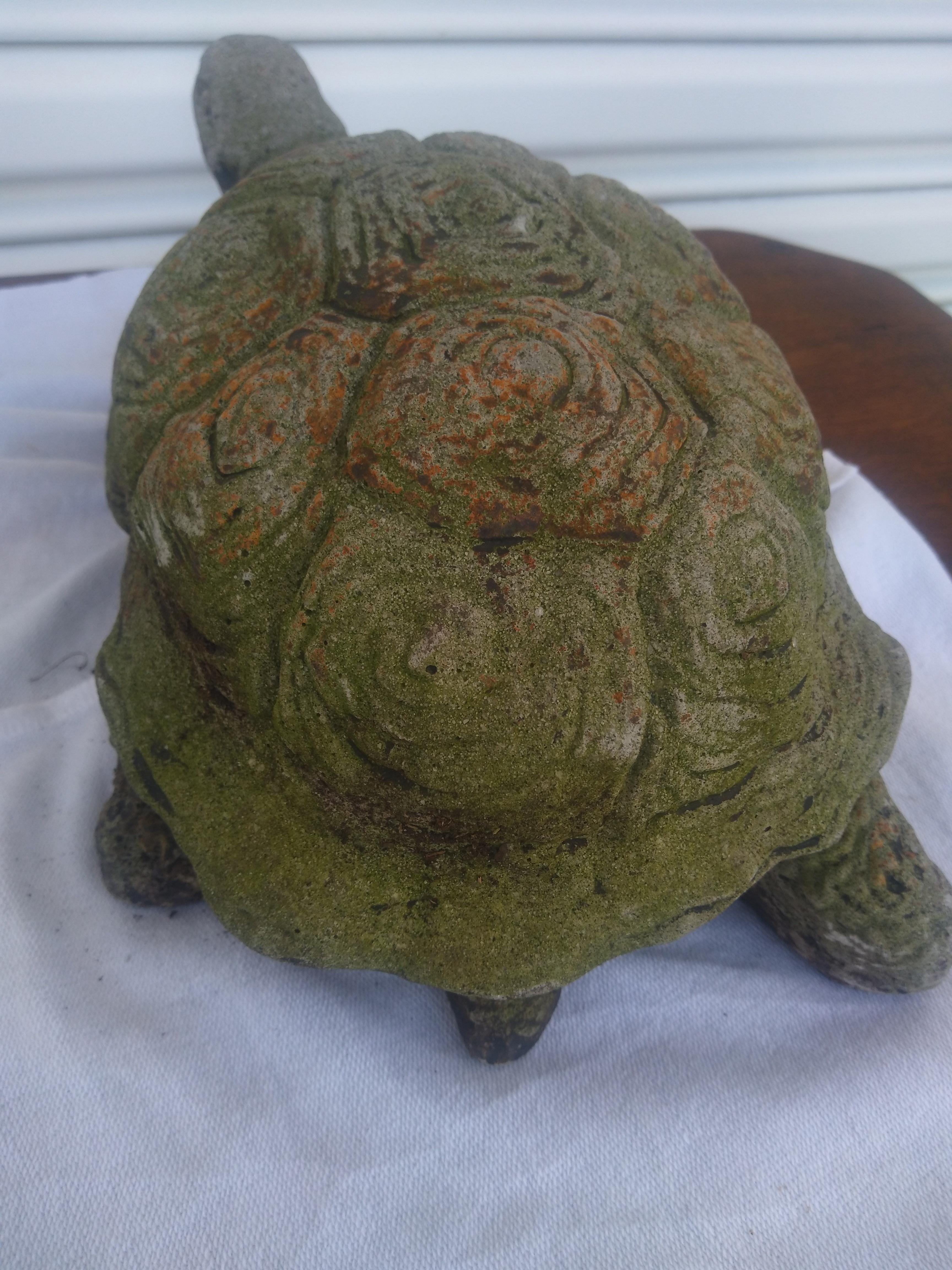This garden statue is made of reconstituted stone. It has detailed carving on it's shell and a nice aged patina. 