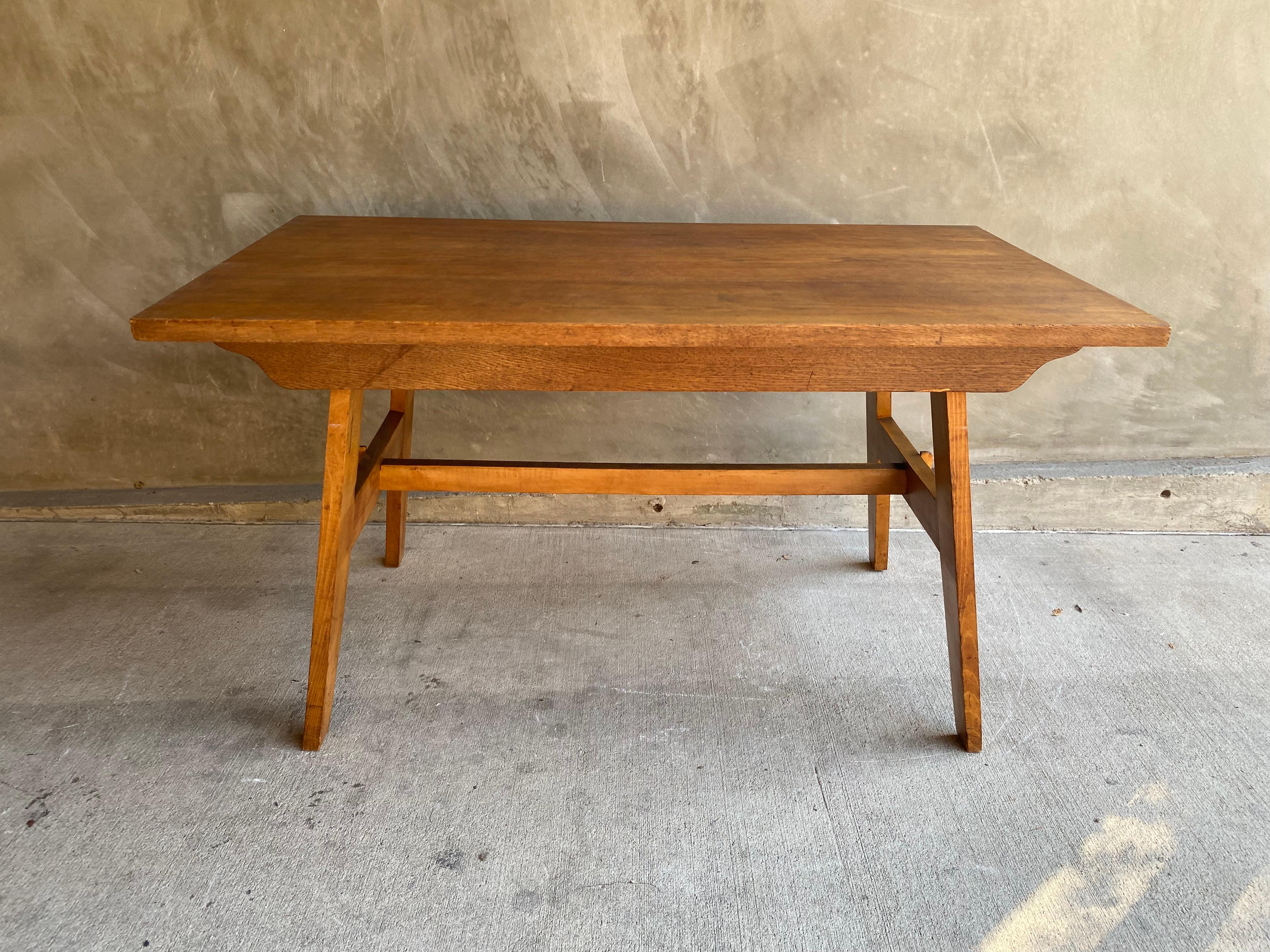 Oak dining table by collectible designer, Rene' Gabriel. From the post-war reconstruction style of modernism or early mid-century modern. Trestle base and apron on long sides. France, 1948-50