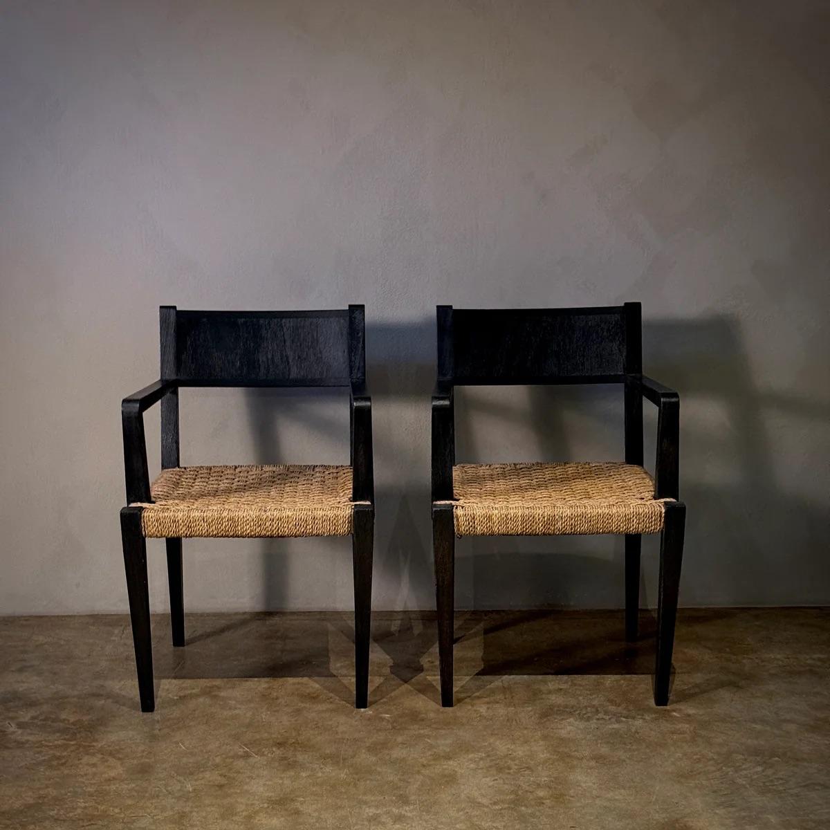This pair of Reconstruction chairs features a striking contrast between the black wooden frame and the woven rush seats. The clean lines and functional elegance reflect a post-war design ethos, emphasizing durability and understated beauty.

France,