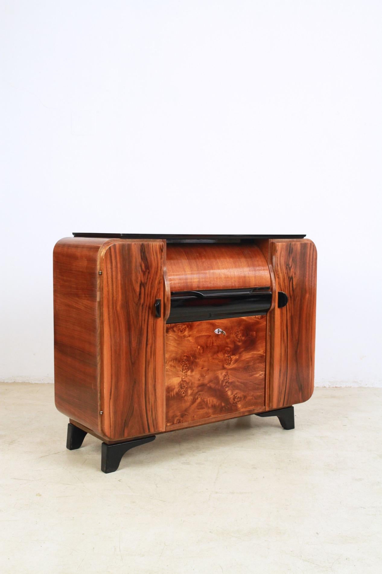 This music cabinet was designed by Jindrich Halabala in the 1930s, but due to its popularity stayed in production until 1960s. The cabinet was designed to house a record player and its records. What makes this piece unique is that while purely