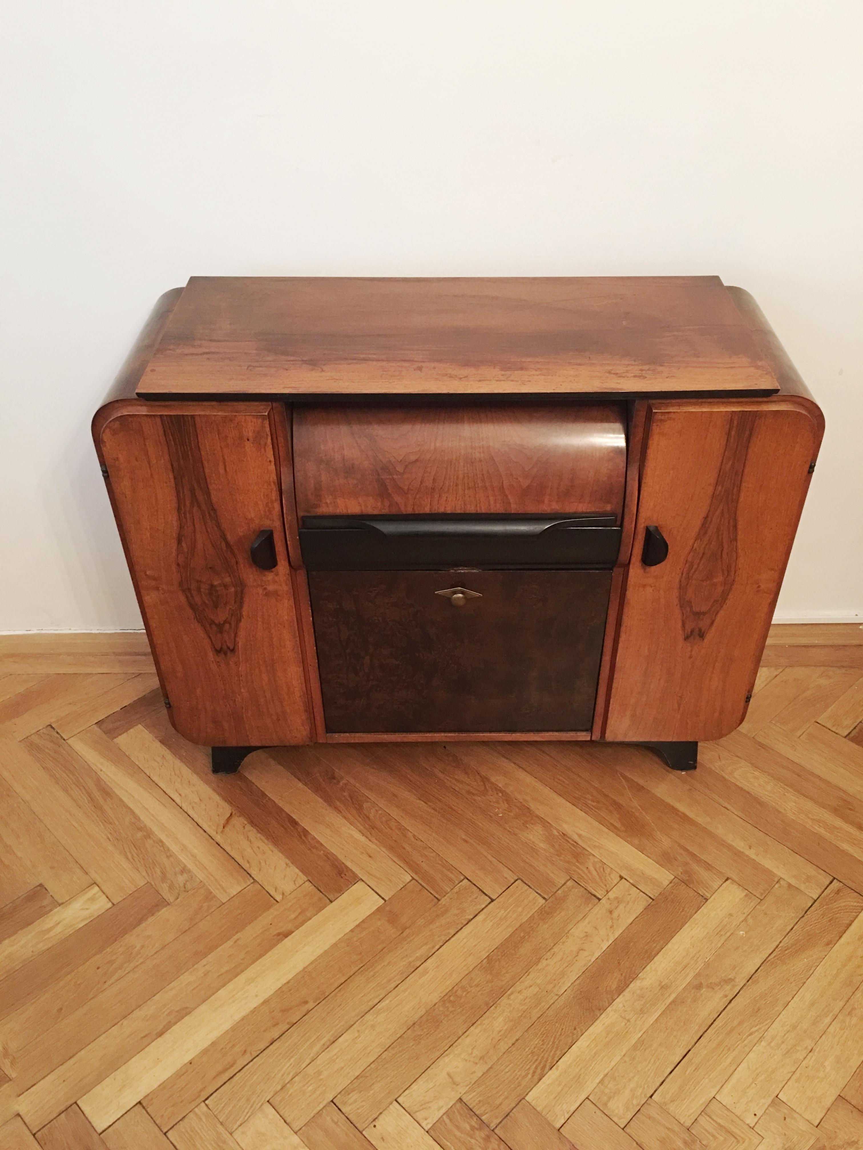 This music cabinet was designed by Jindrich Halabala in the 1930s, but due to its popularity stayed in production until 1960s. The cabinet was designed to house a record player and its records.