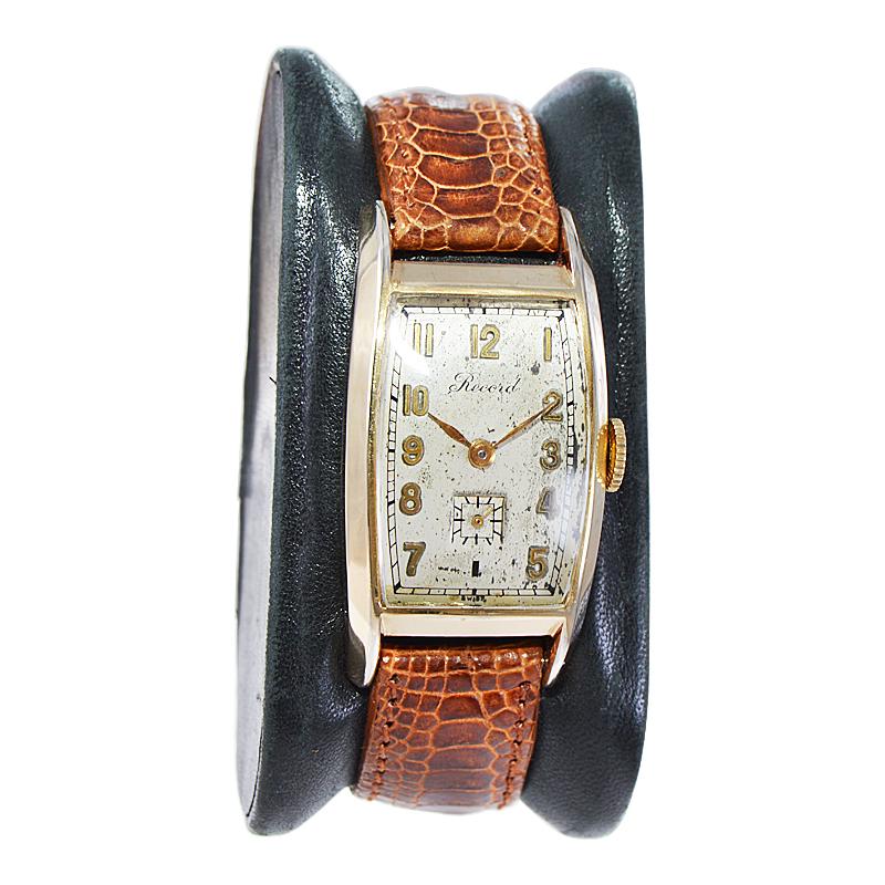 FACTORY / HOUSE: Record Watch Company
STYLE / REFERENCE: Art Deco / Tonneau Shape
METAL / MATERIAL: Yellow Gold Filled 
CIRCA / YEAR: 1940's
DIMENSIONS / SIZE: Length 40mm x Width 22mm
MOVEMENT / CALIBER: Manual Winding / 17 Jewels / Cal.102
DIAL /