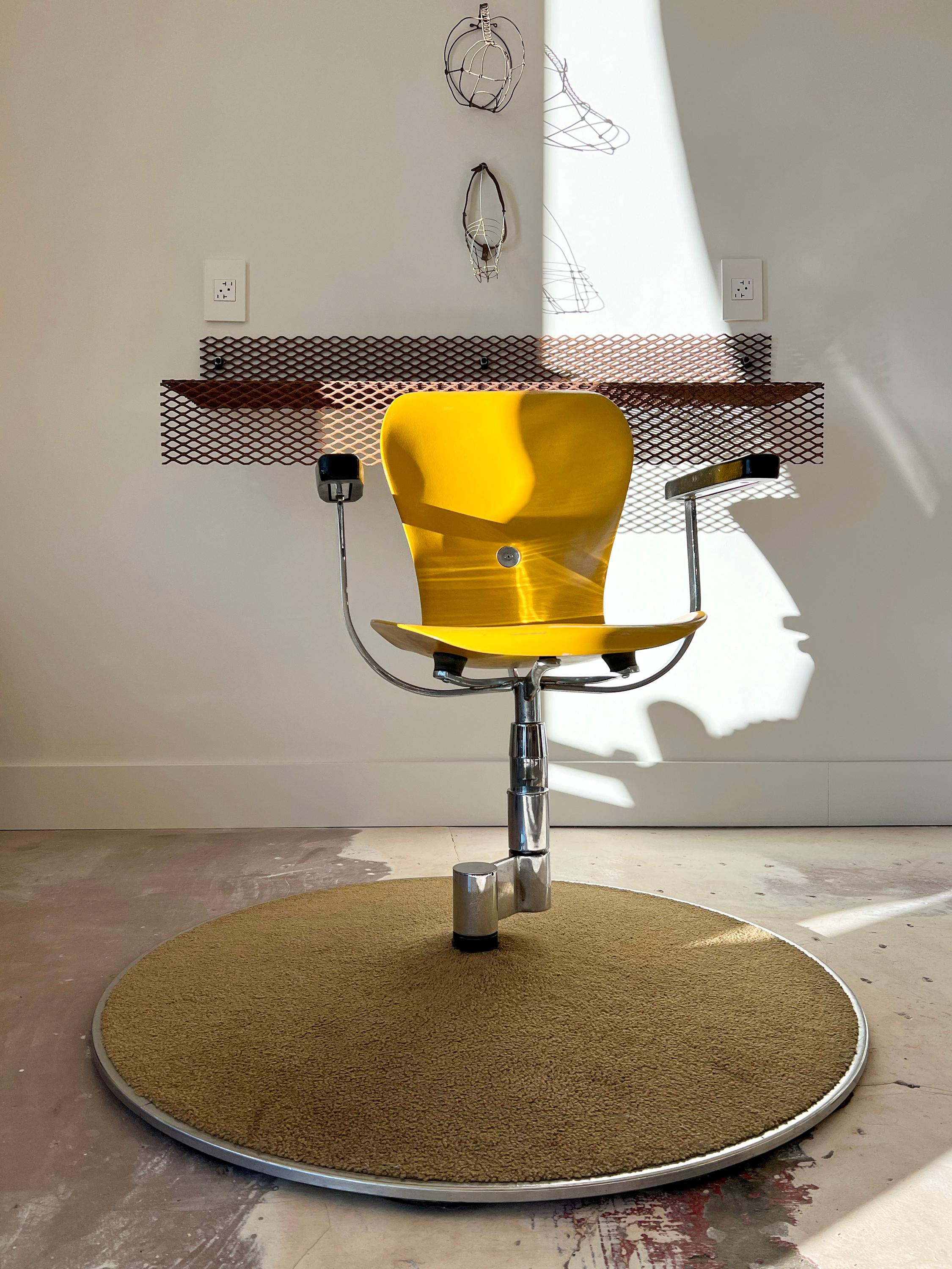 Designed in 1962 by Gideon Kramer, the Recorder's Chair was used on the observation deck of the Space Needle at the World's Fair in Seattle. Swings and rotates smoothly, all gliding points have been oiled and work properly. Upholstered base is