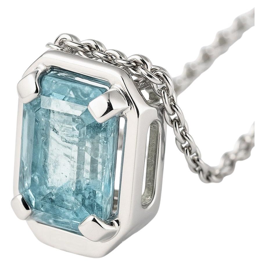 This necklace pendant features a 9.2mm x 6.2mm rectangle-cut aquamarine, renowned for its tranquil light blue hue and exceptional clarity. The gemstone is set within a sterling silver framework that combines minimalism with structural integrity. The