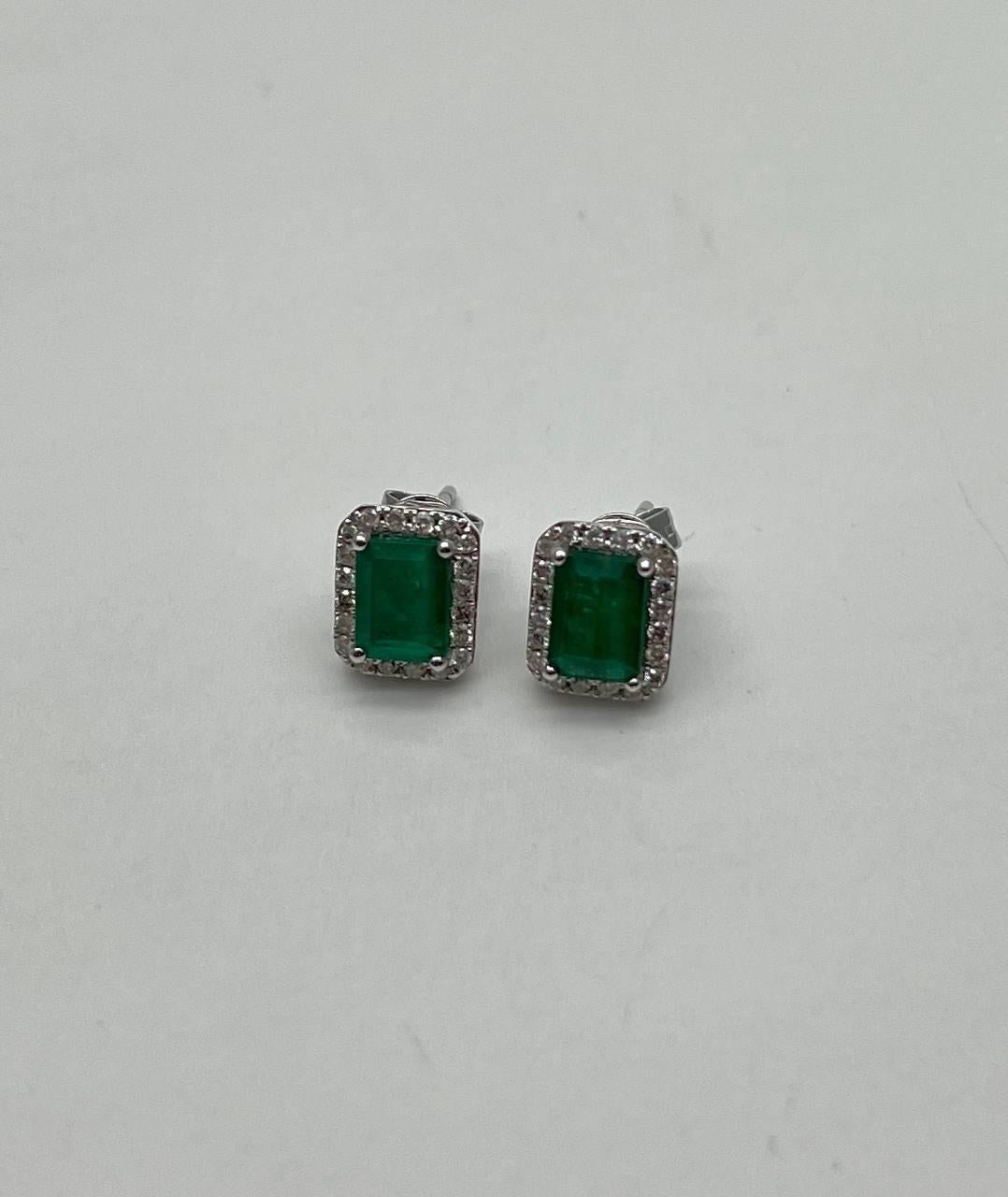 Emerald elegance captured in these exquisite stud earrings. Each piece features a vibrant green emerald, framed by a halo of shimmering white stones, set in a sleek metal finish.
Timeless and sophisticated adornments. 14K White Gold. 0.25 CTW