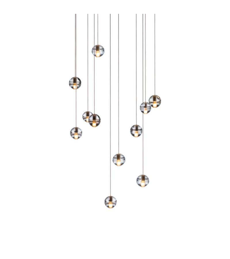 Lampe lustre rectangulaire 14.11 de Bocci
Dimensions : P 28,4 x L 85 x H 300 cm 
Matériaux : Nickel brossé, verre moulé, verre borosilicaté soufflé, câble coaxial en métal tressé, composants électriques, capotage en poudre blanche.
Disponible en