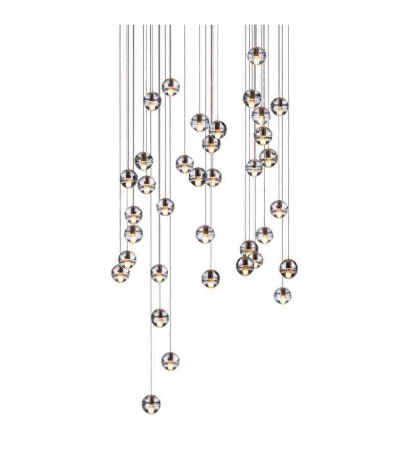 Rectangular 14.36 chandelier lamp by Bocci
Dimensions: D 37 x W 110 x H 300 cm
Materials: brushed nickel, cast glass, blown borosilicate glass, braided metal coaxial cable, electrical components, white powder-coated canopy.
Available in square,