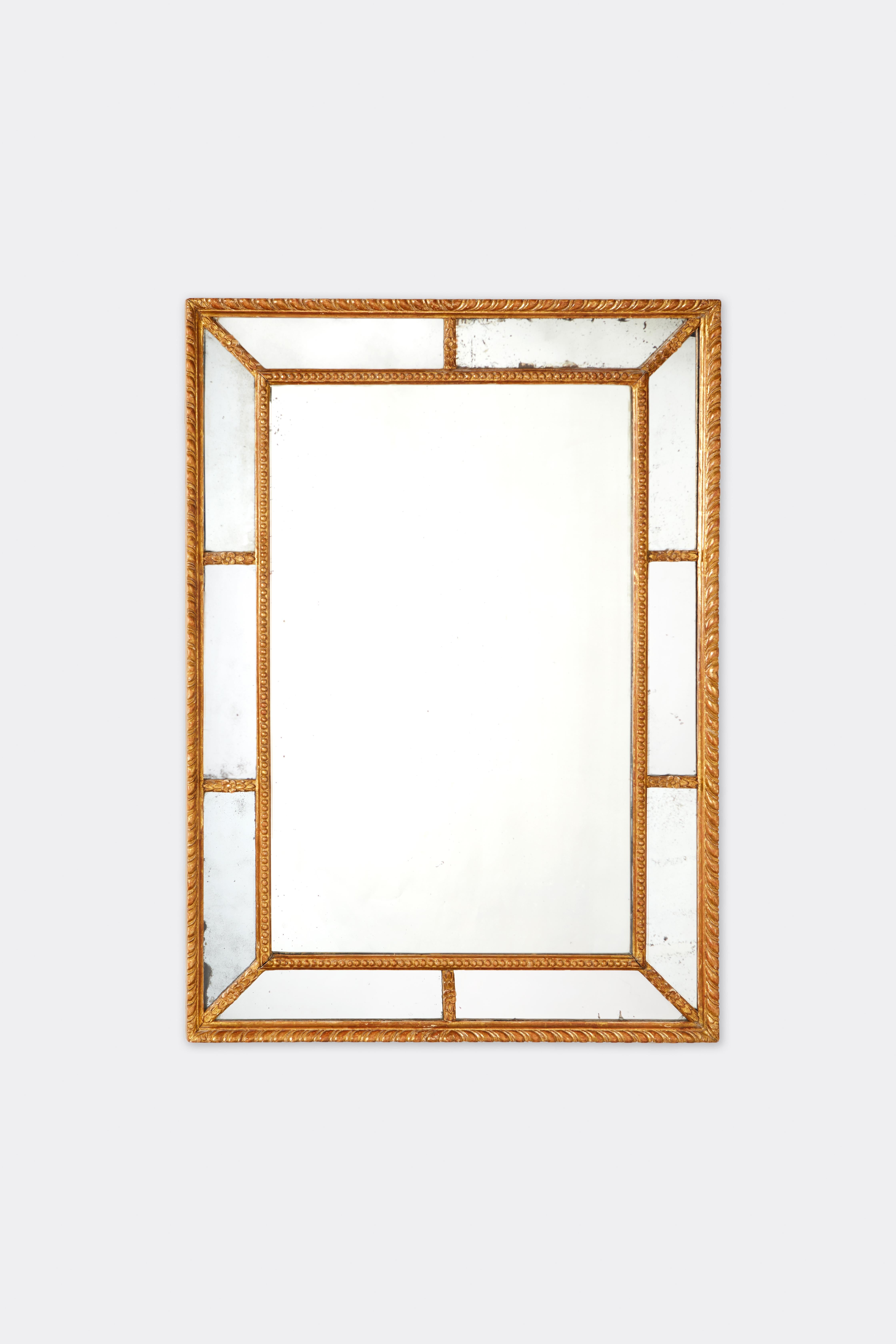 Miroir rectangulaire géorgien du XVIIIe siècle, avec des sections en miroir dans le cadre, et des détails en bois doré sculpté, y compris des granulations, des rosettes et des motifs torsadés.