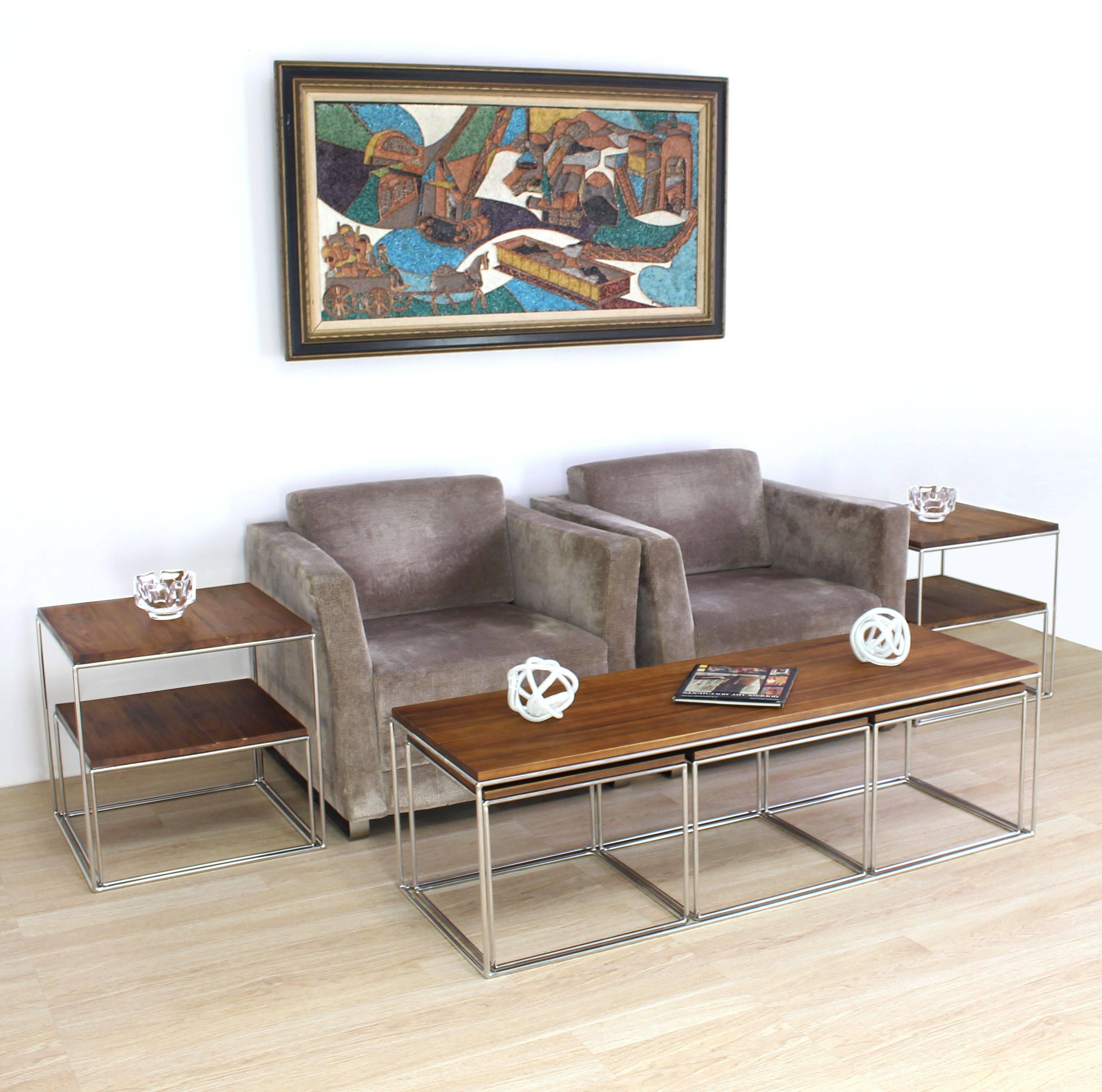 Box shaped set of 4 coffee tables by Established Lines. Mirror polished solid stainless steel rod frame bases coffee table with three 18 x 18 x 15 cube shape nesting tables.
The elegant design four pieces table features countless functions and