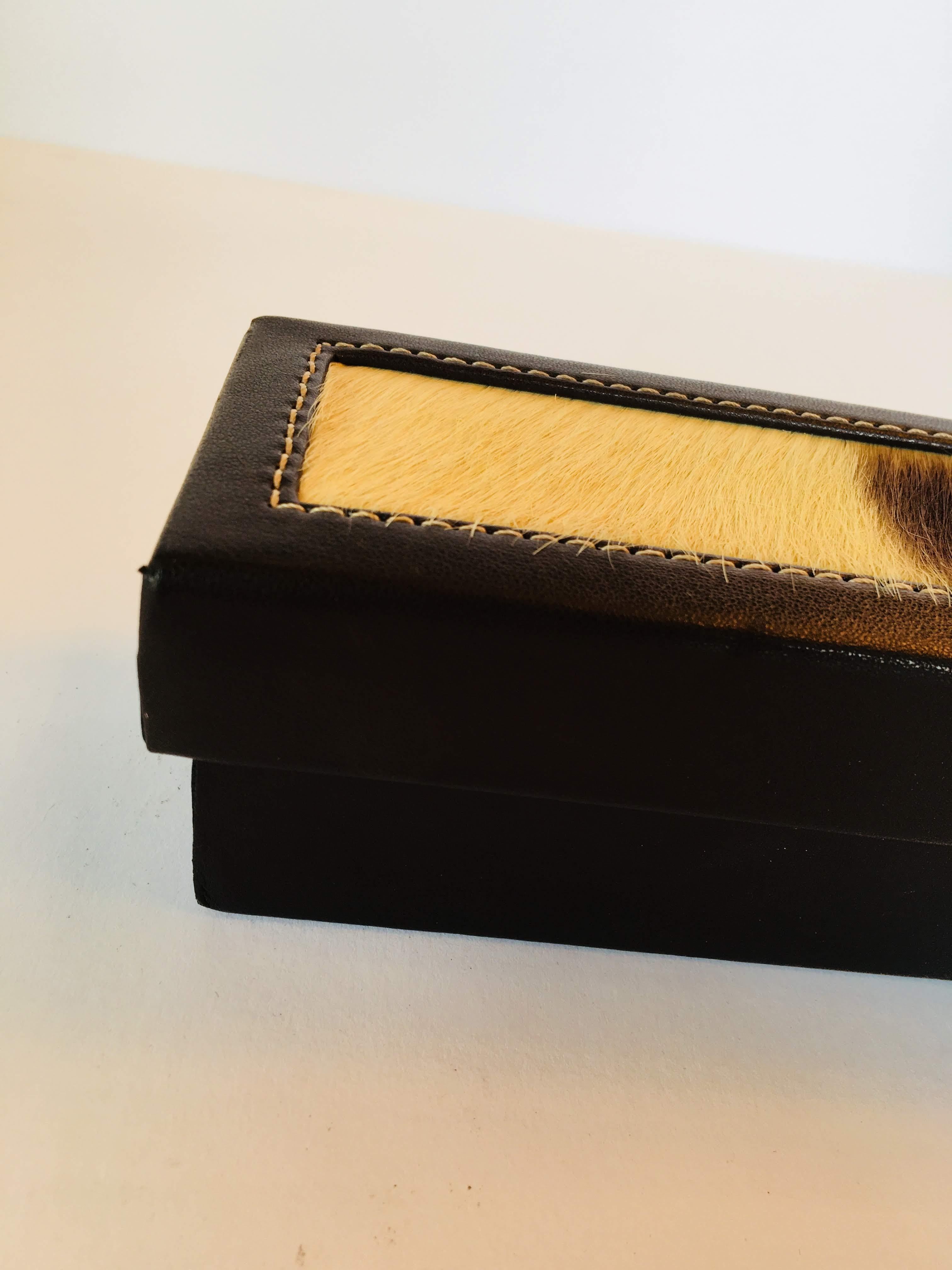 Rectangular leather African box with lid and animal hair.