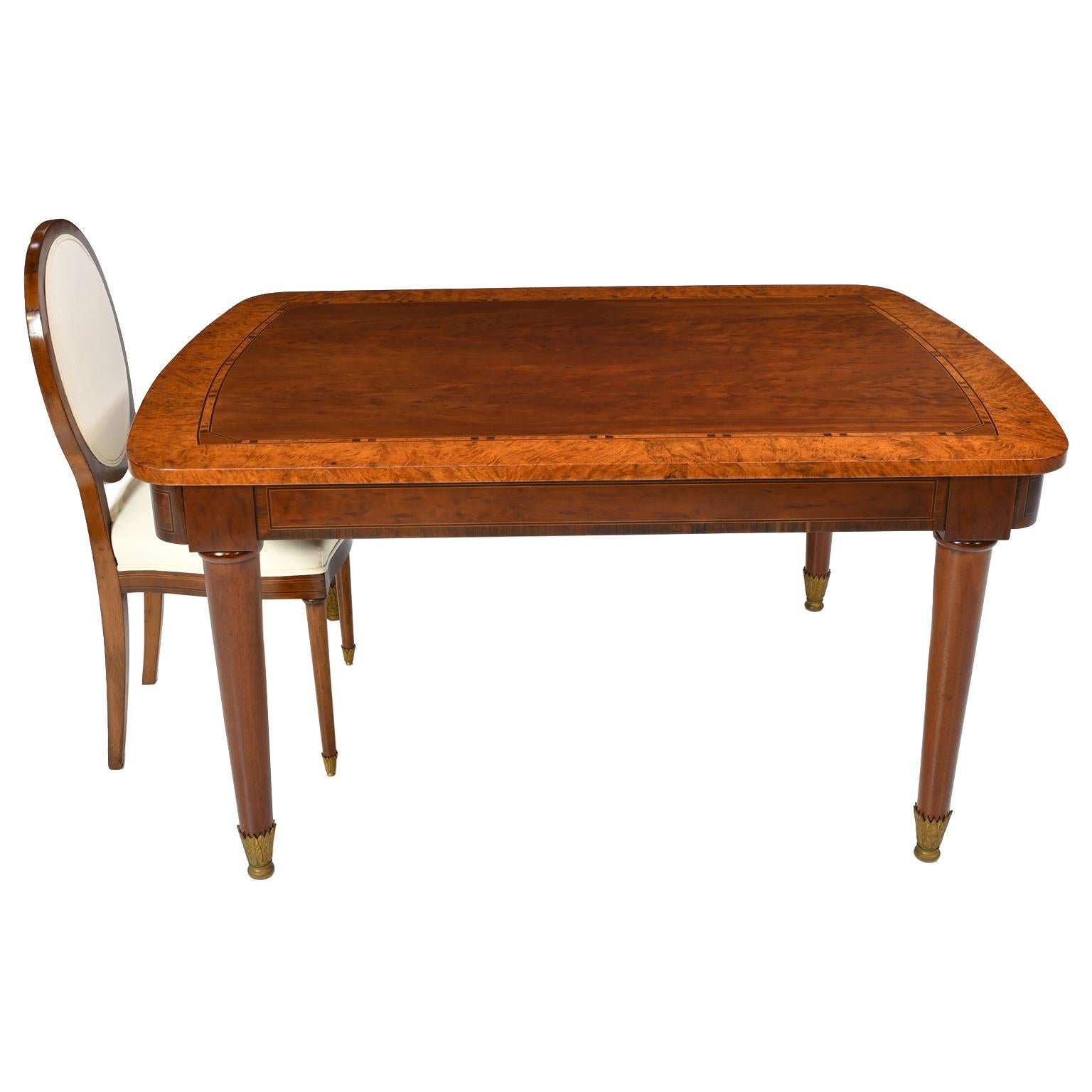 This unique early Art Deco rectangular table made in Brussels at the fabric of A. Brants - Tonnemans is made of book matched quilted plum mahogany, root wood and various woods like kingwood, satinwood, ebony, and rosewood for the line inlays and