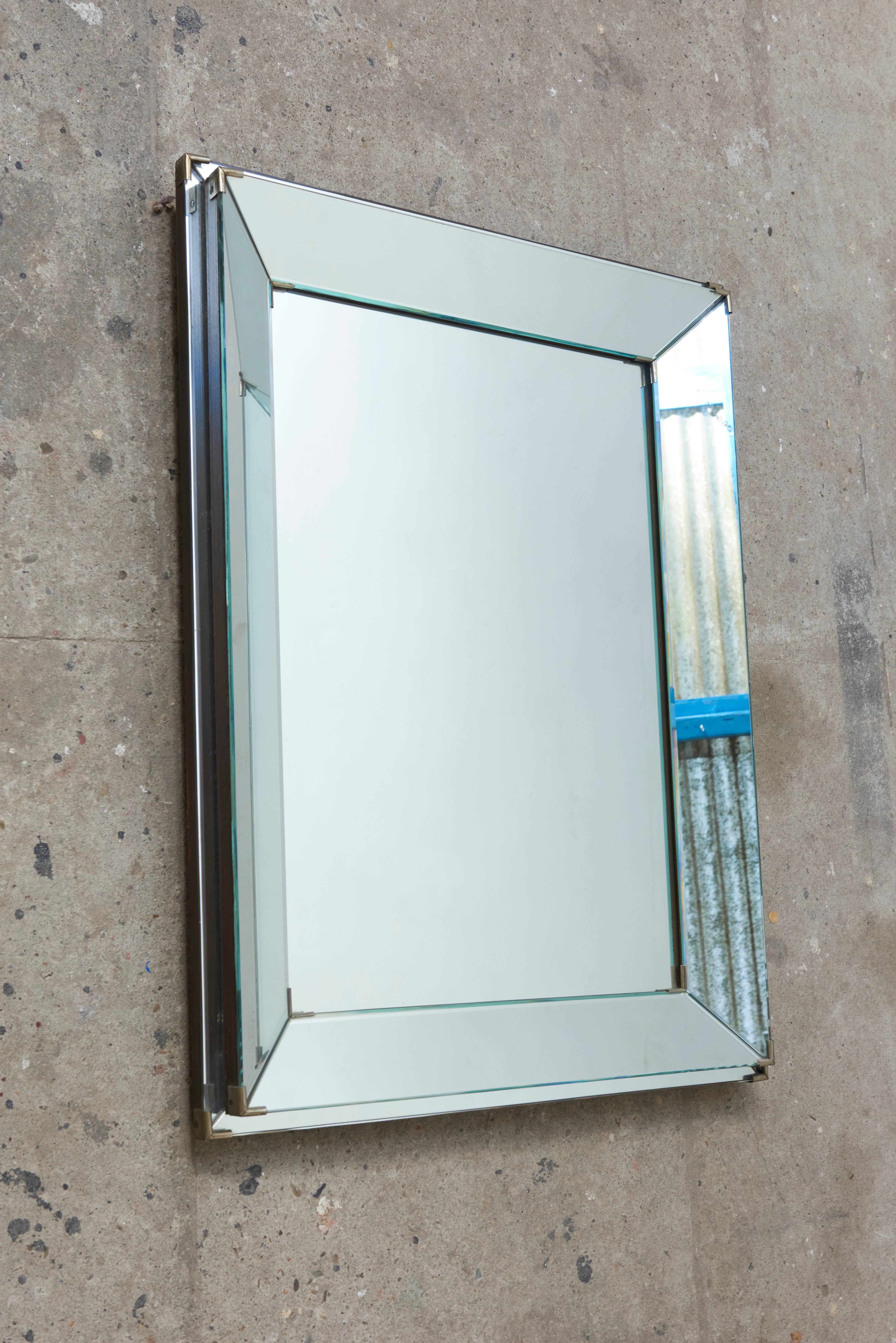 A fine and rare Art Deco rectangular mirror with brass corner accents on solid wood, circa 1920.

 