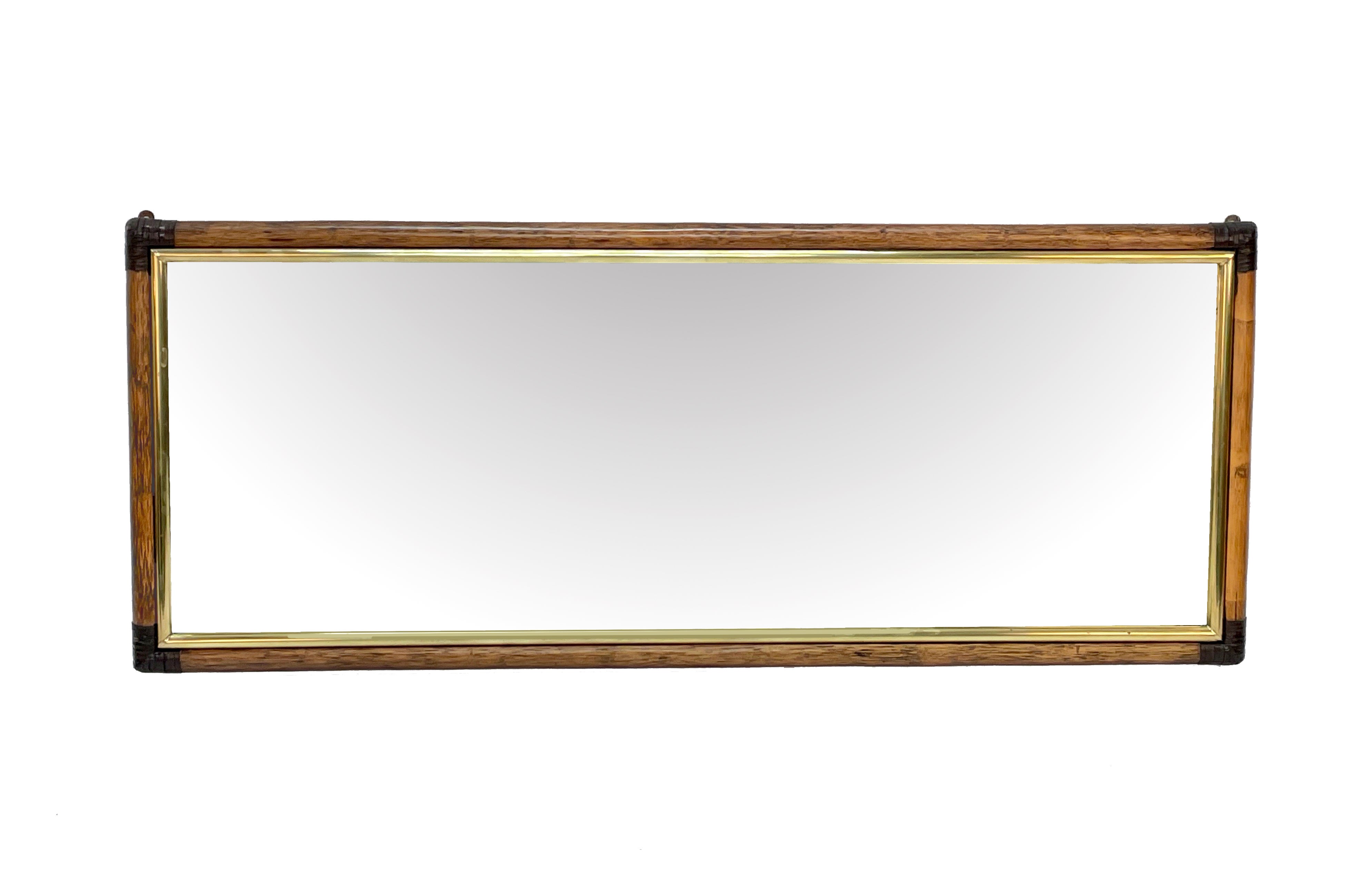 Amazing large rectangular bamboo cane, brass and brown leather. This wonderful mirror was designed in Italy during the 1970s.

This item has a rattan frame tied with a leather cord in the corners with an internal brass frame that enriches the