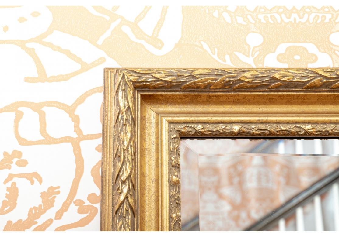 Hollywood Regency Rectangular Beveled Gilt Mirror With Carved Laurel Leaves For Sale