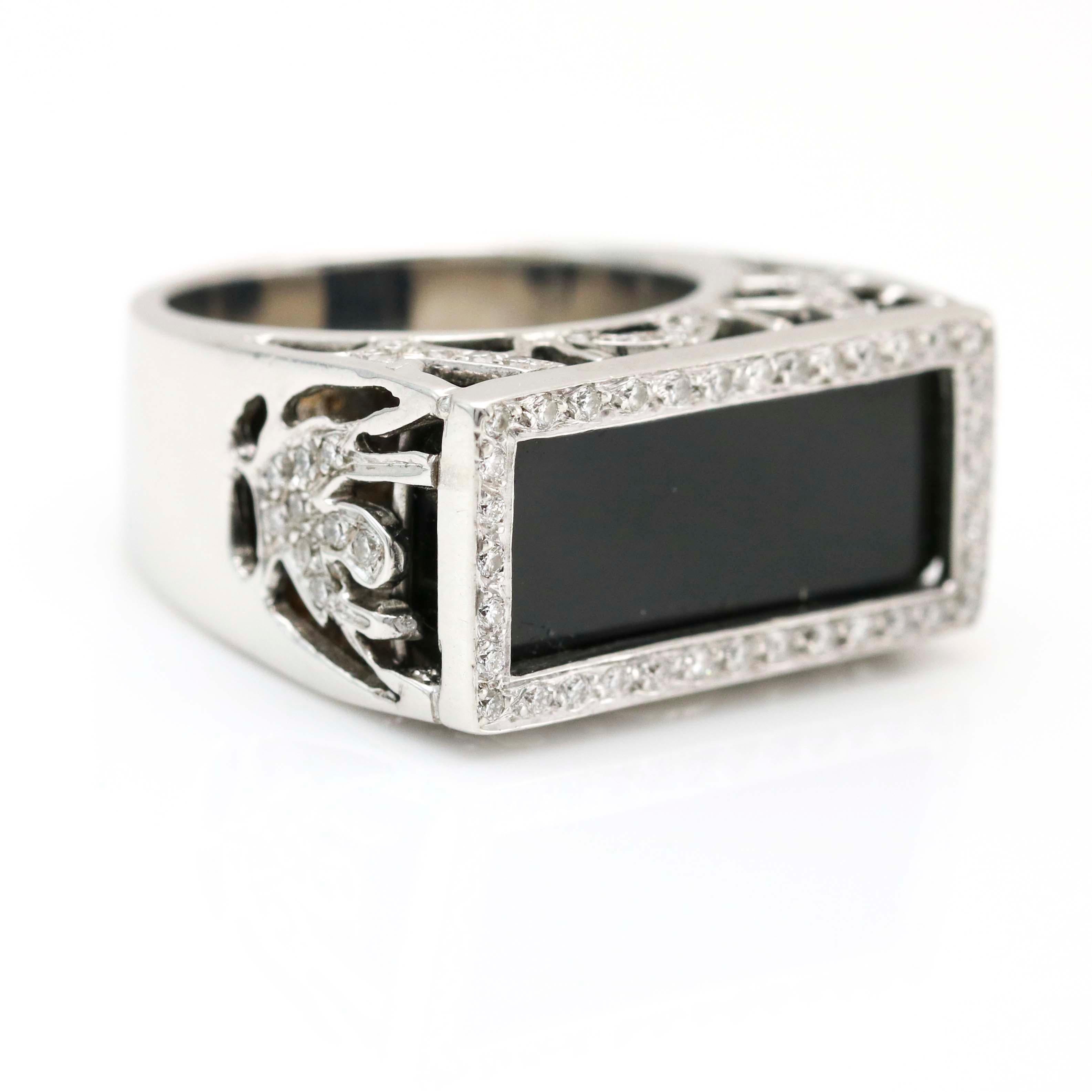 Rectangular black onyx ring with diamonds crafted in 18 karat white gold. Size 7. Signed SiNDi. Diamond carat total weight, 1.10 carats,

Width, 12mm. Weight, 18 grams. Carat total weight, 1.1 carats. 