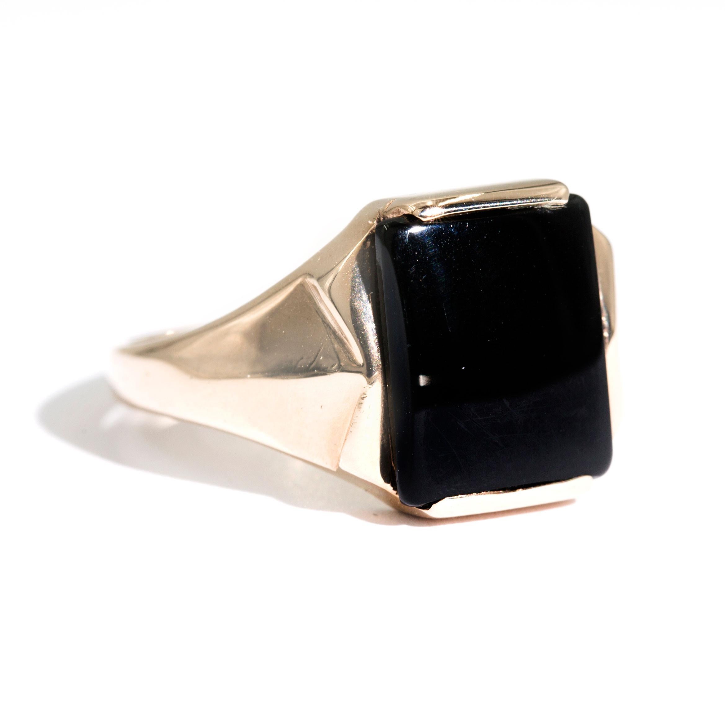 Crafted in 9 carat yellow gold is this handsome vintage mens signet ring featuring a black onyx and seamlessly flows down to pleated sides . We have named this dapper piece The Oscar Ring. The Oscar Ring has a high polished band, and the unique