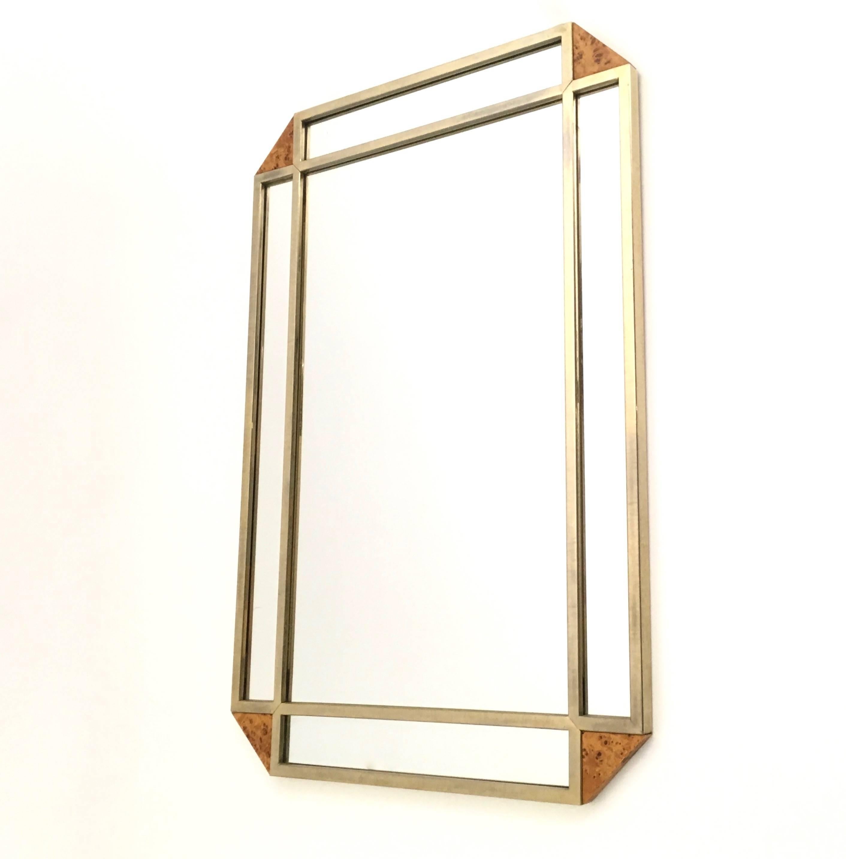 Made in Italy. 
This rectangular wall mirror features a steel frame and canted blond root corners.
It may show slight traces of use since it's vintage, but it can be considered as in very good original condition and ready to become a piece in a