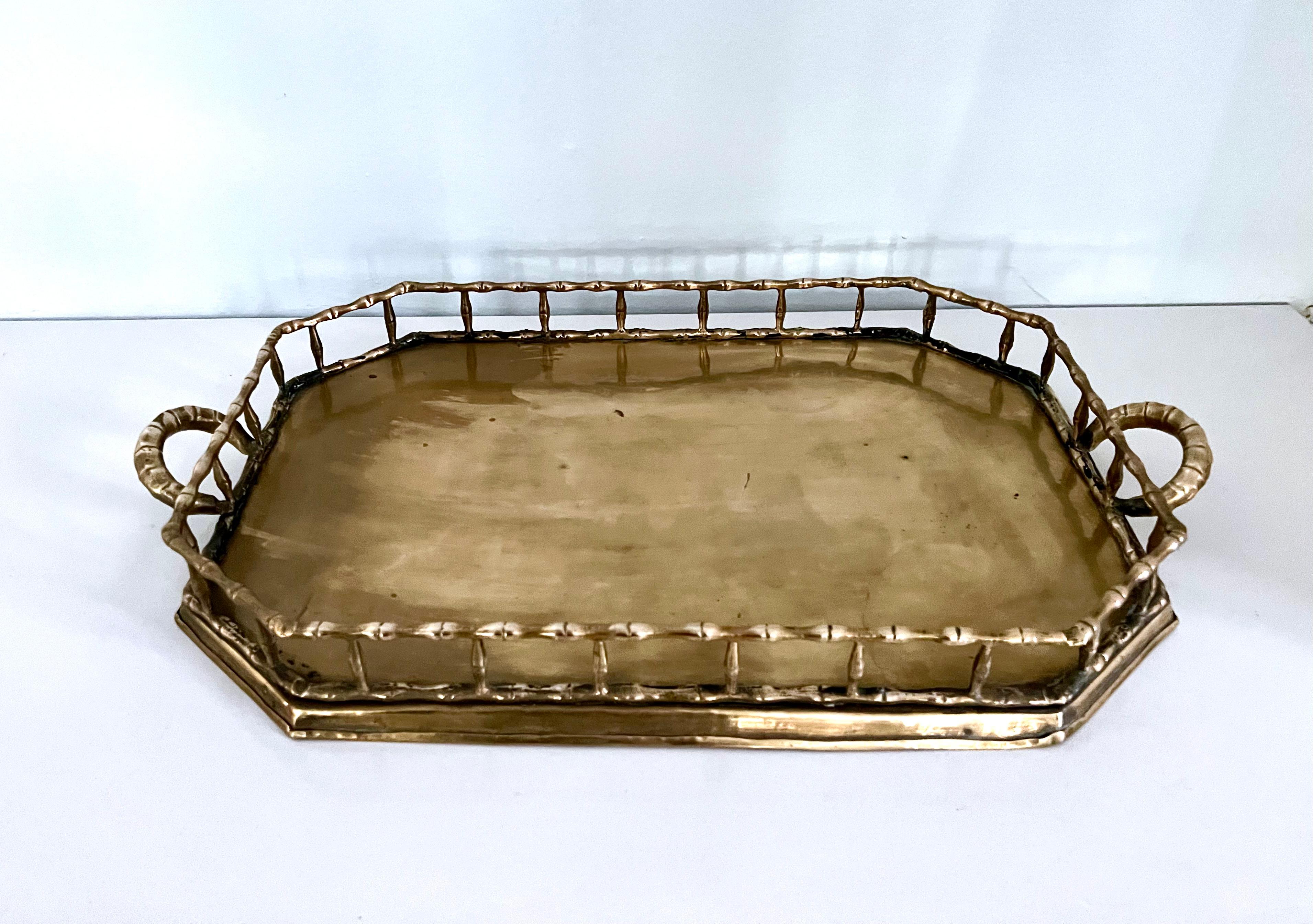 A large vintage Hollywood regency style brass bamboo tray. Great for display on coffee tables or serving cocktails. Polished and patinated. 

 