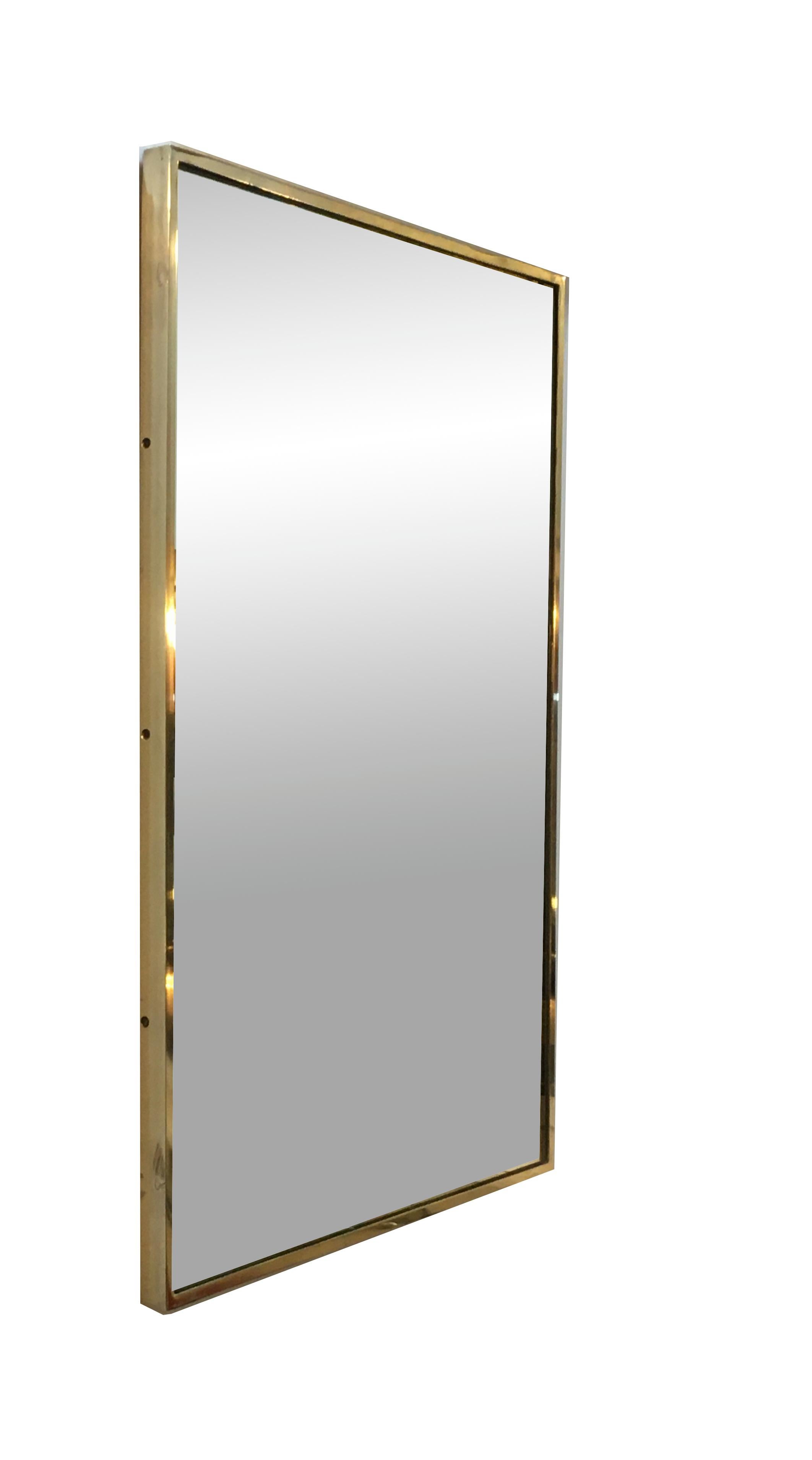 Italian rectangular wall mirror with brass frame on wooden base. A simple and elegant design in good vintage condition.
 this piece is stylistically related to the designer Gio Ponti, Romeo Rega