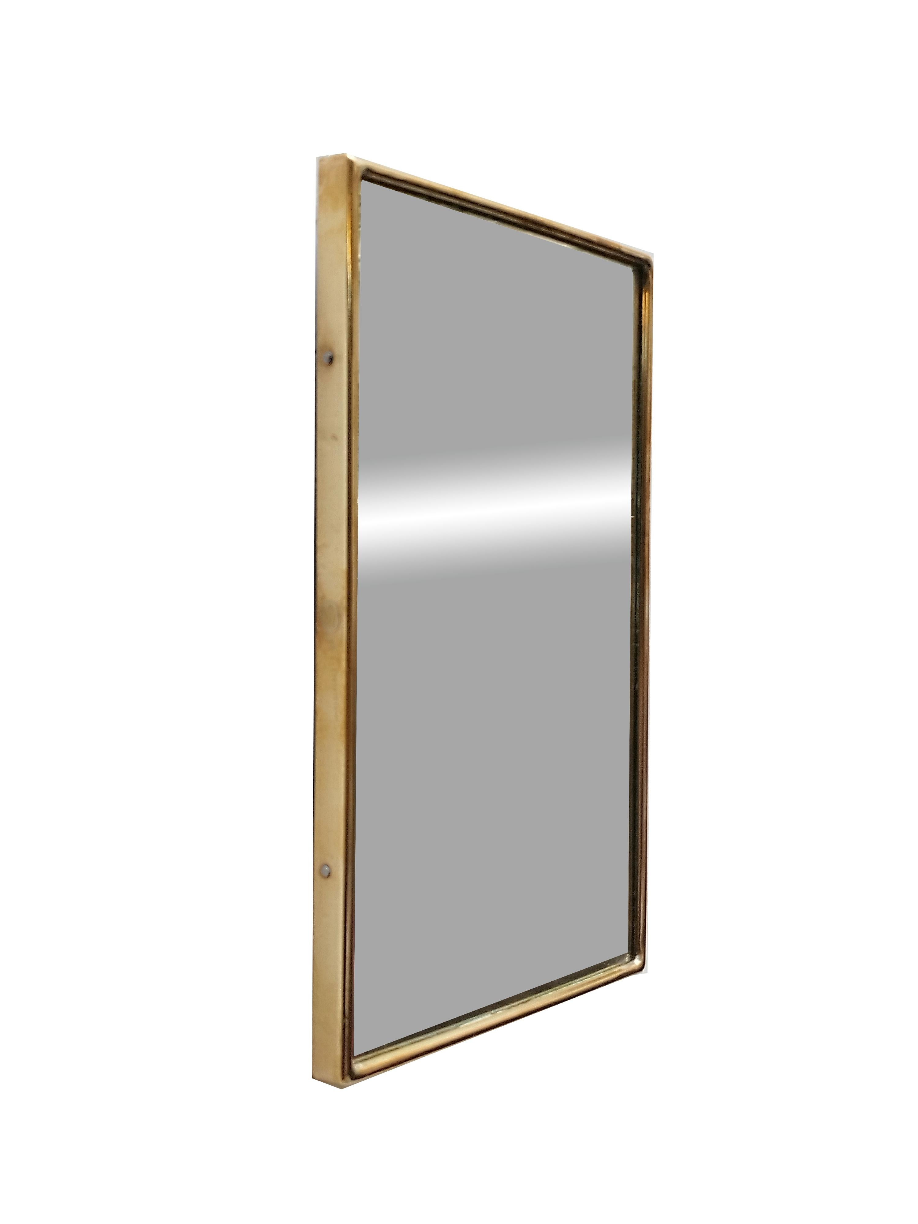 Small rectangular mirror with brass frame, 1960s. Showing some minor signs of time, the mirror is original to the period.